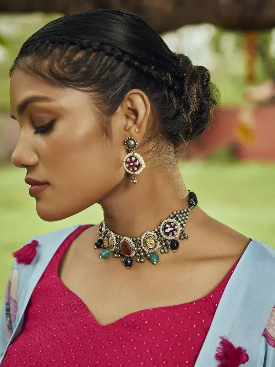 Woman in pink ethnic wear with ornate choker necklace and matching earrings, styled for traditional Indian occasions