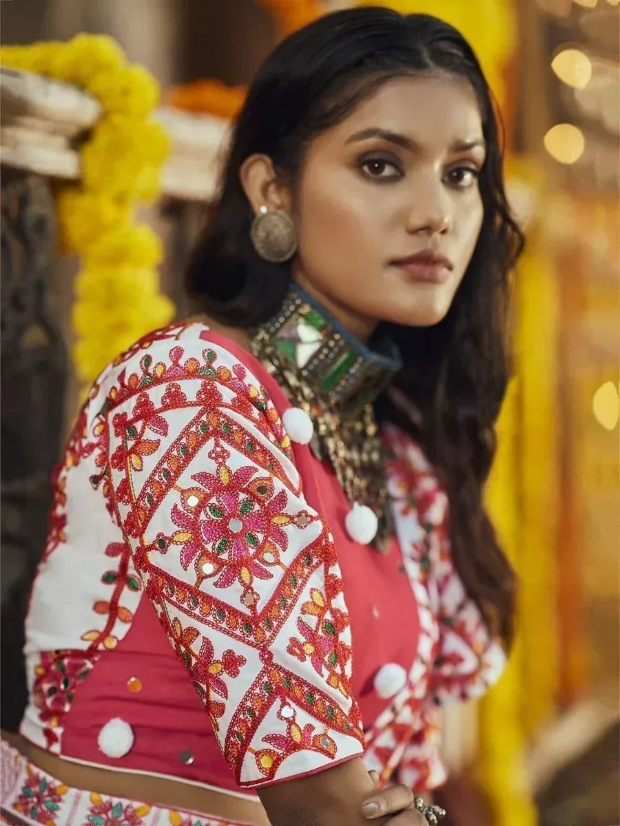 Woman in embroidered pink and white ethnic blouse with mirror work, traditional Indian attire
