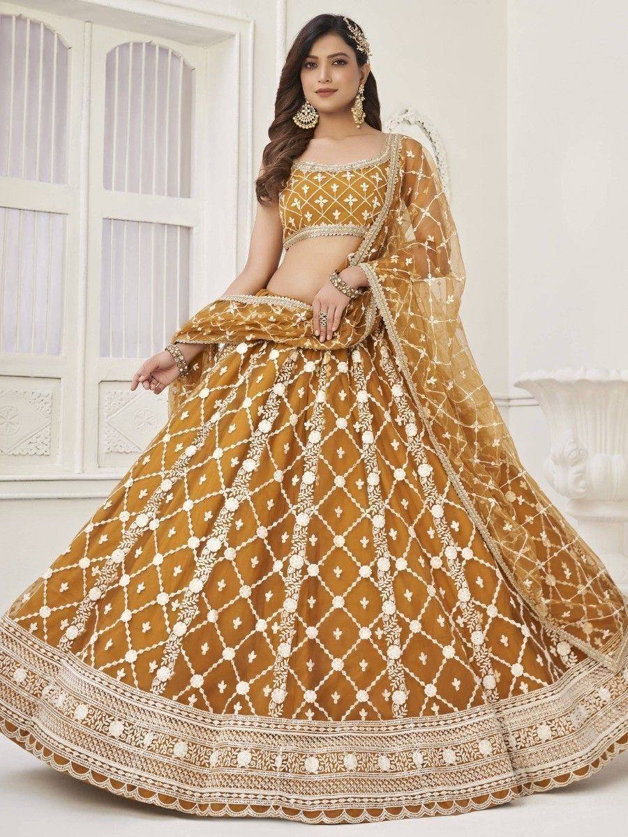 Mustard yellow lehenga choli with white embroidery, perfect for Indian weddings and festive occasions