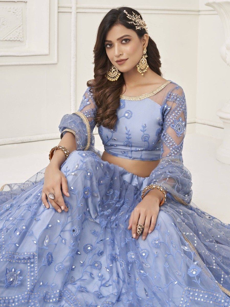 Light blue embroidered lehenga choli with sheer sleeves and gold jewelry, perfect for Indian ethnic occasions