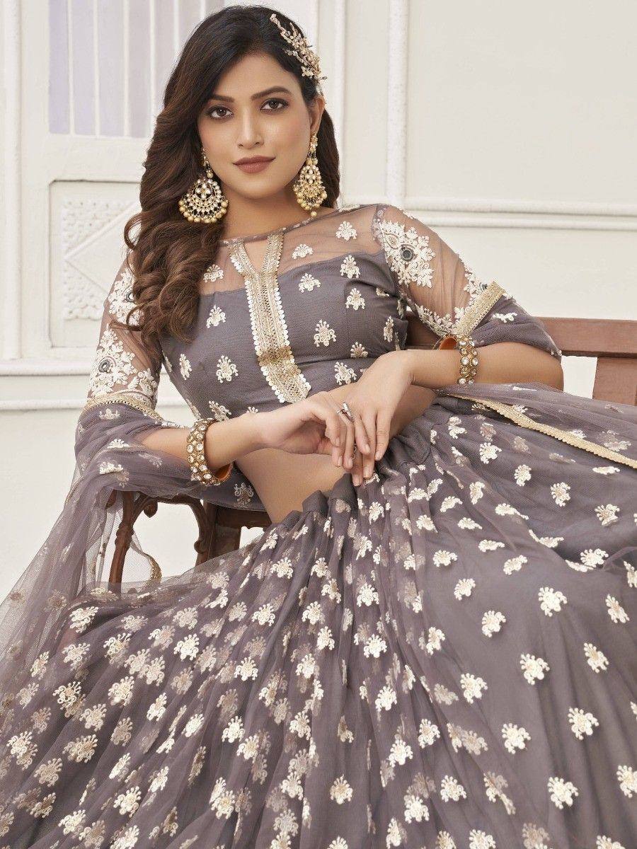 Grey floral embroidered lehenga choli with sheer sleeves and gold jewelry for Indian ethnic wear