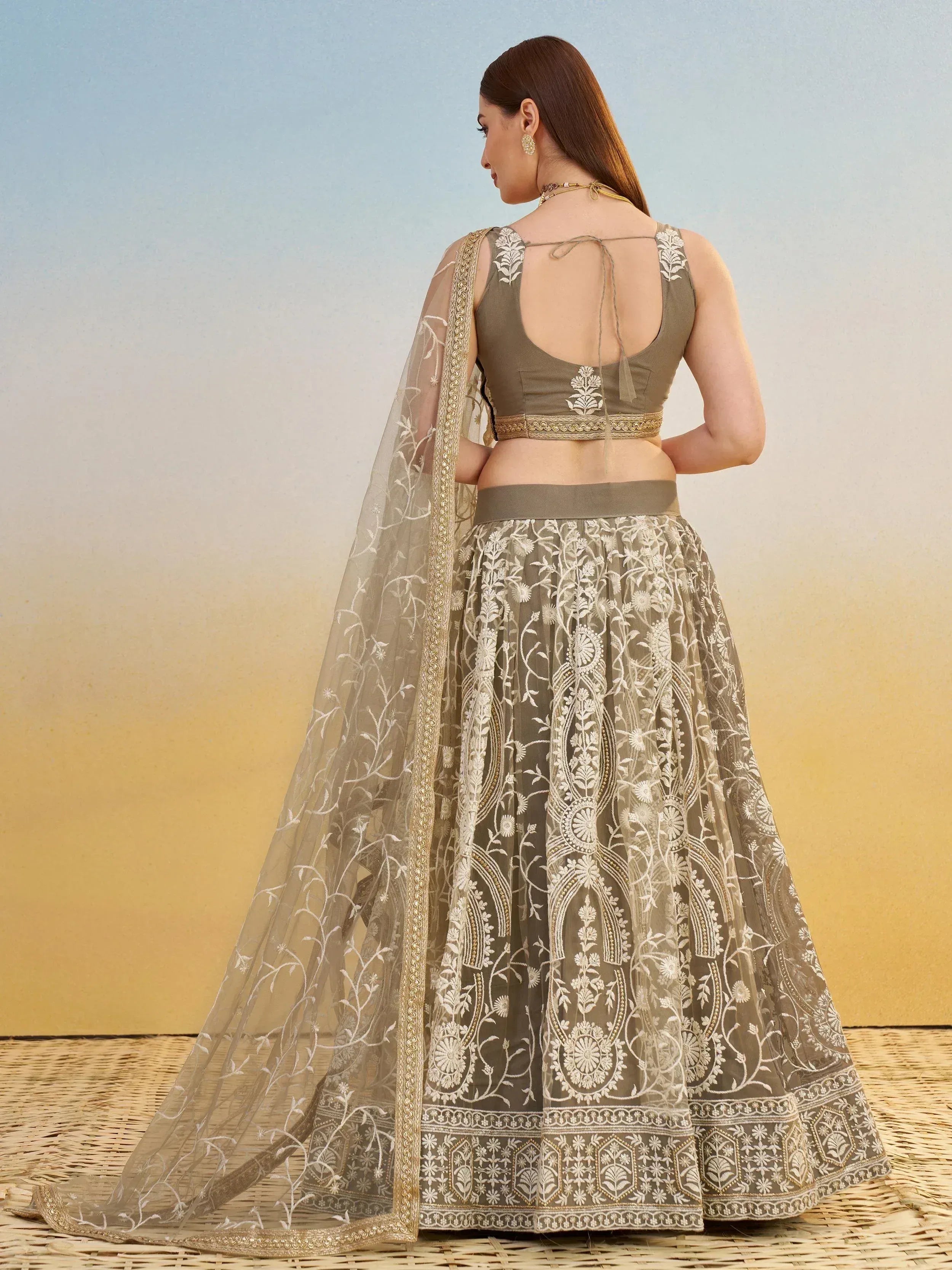 Olive green embroidered lehenga choli with floral motifs and sheer dupatta, ideal for Indian ethnic wear occasions.