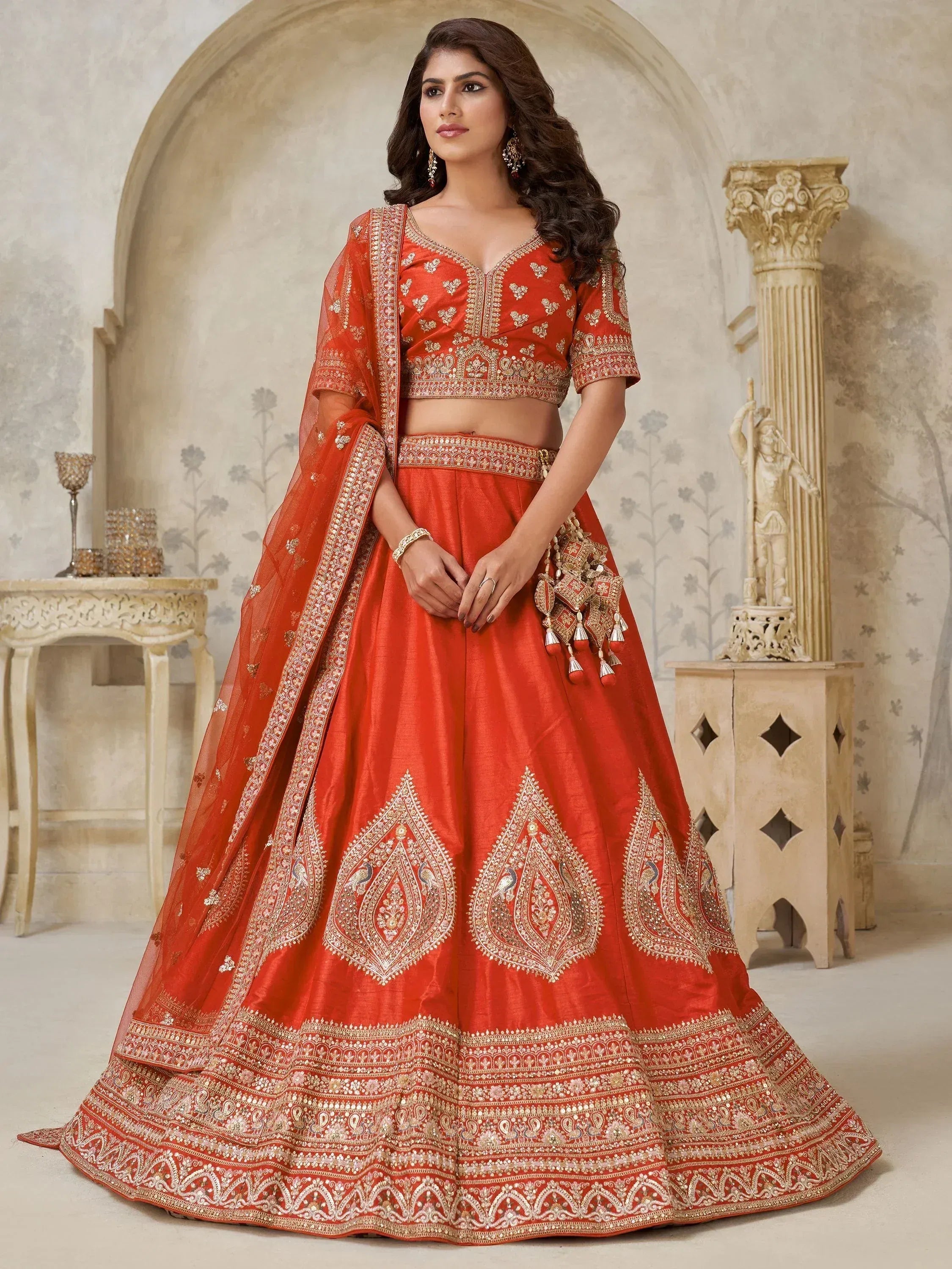 Orange designer lehenga choli with gold embroidery, perfect for weddings and festive occasions