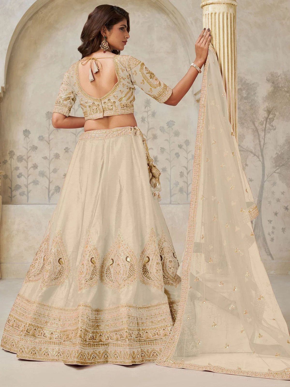 Elegant beige lehenga choli with gold embroidery and sheer dupatta for Indian ethnic wear