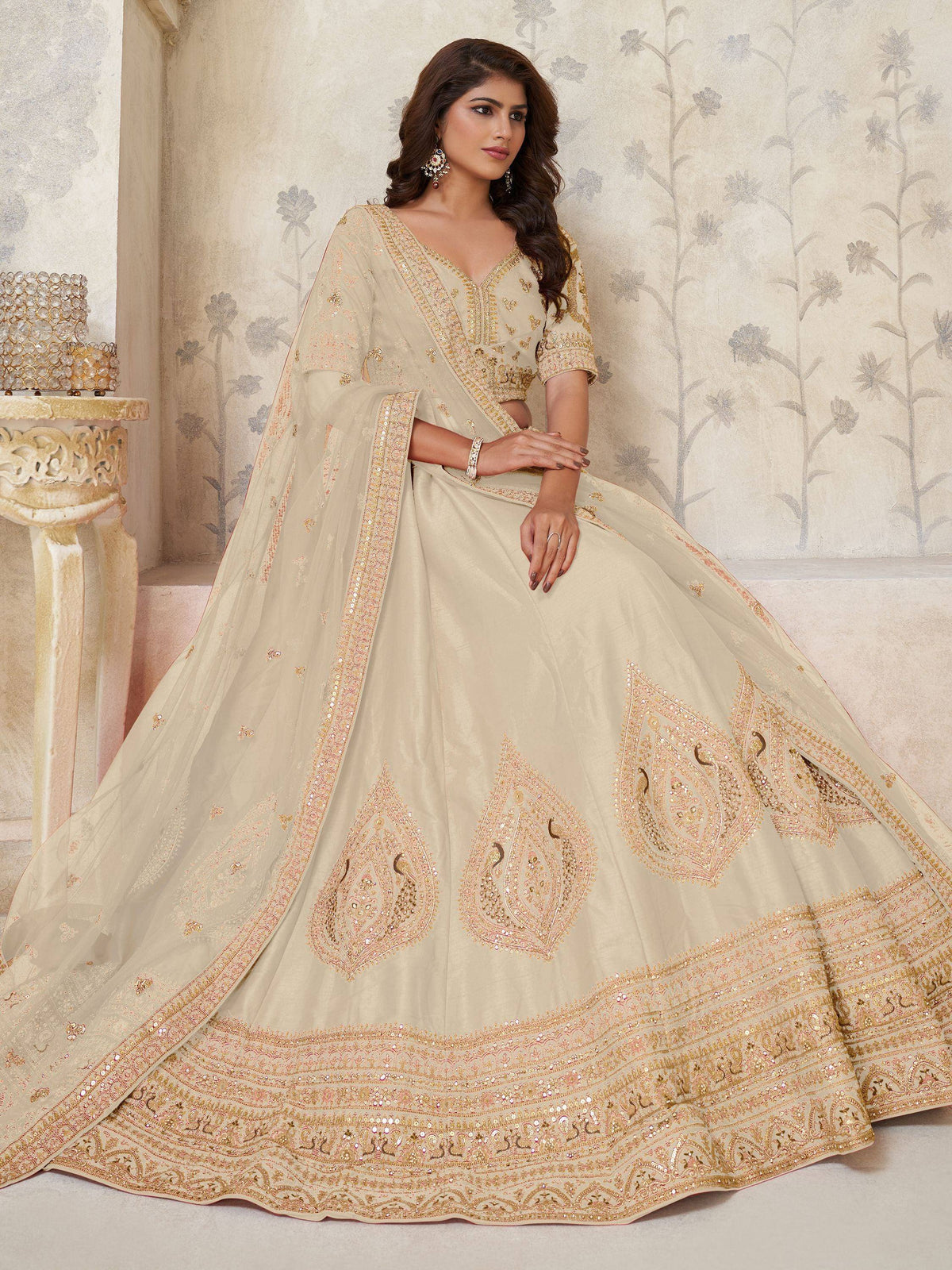 Beige designer lehenga choli with gold embroidery, perfect for weddings and festive occasions.
