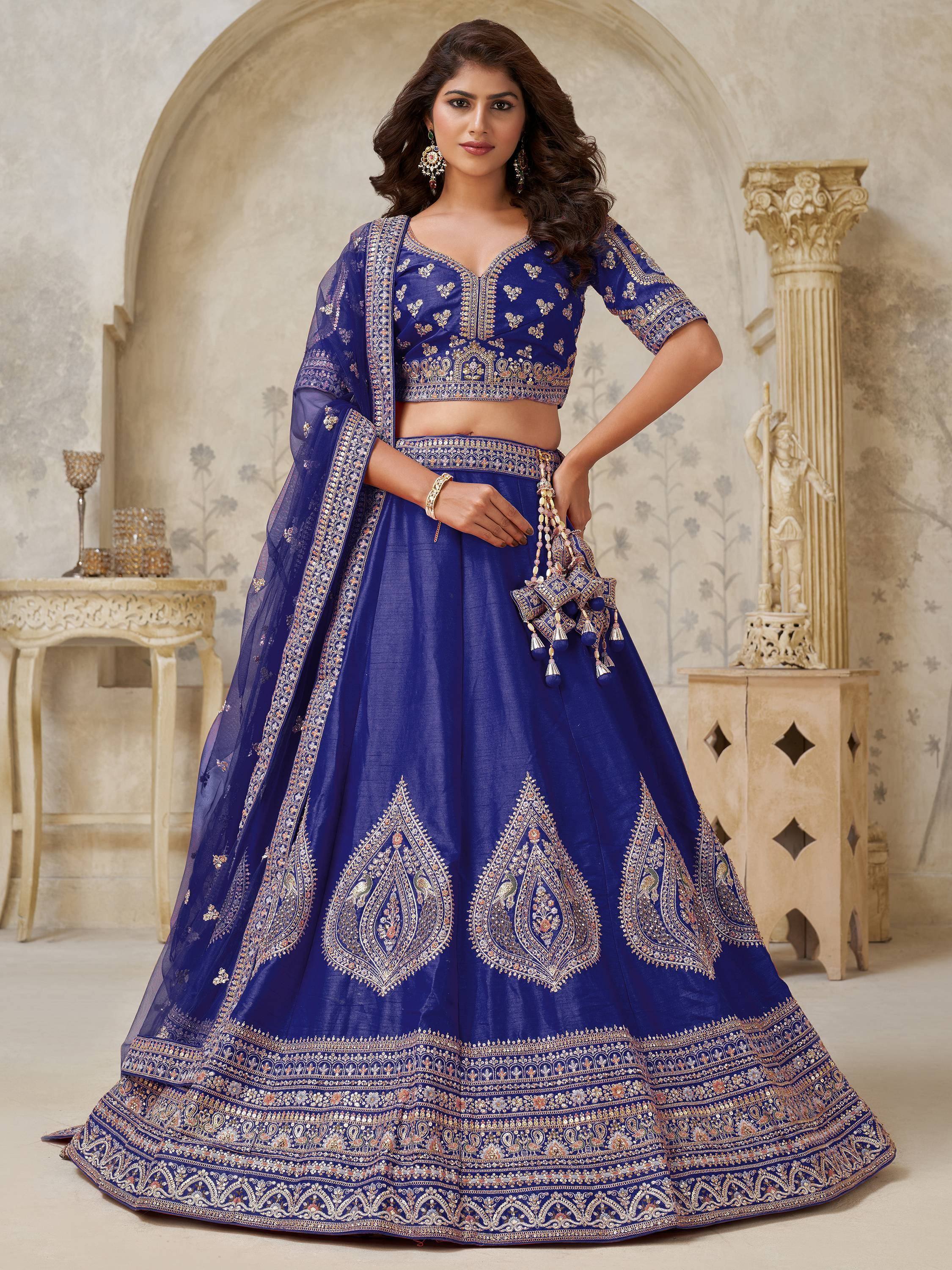 Royal blue embroidered lehenga choli with peacock motifs, perfect for weddings and festive occasions.