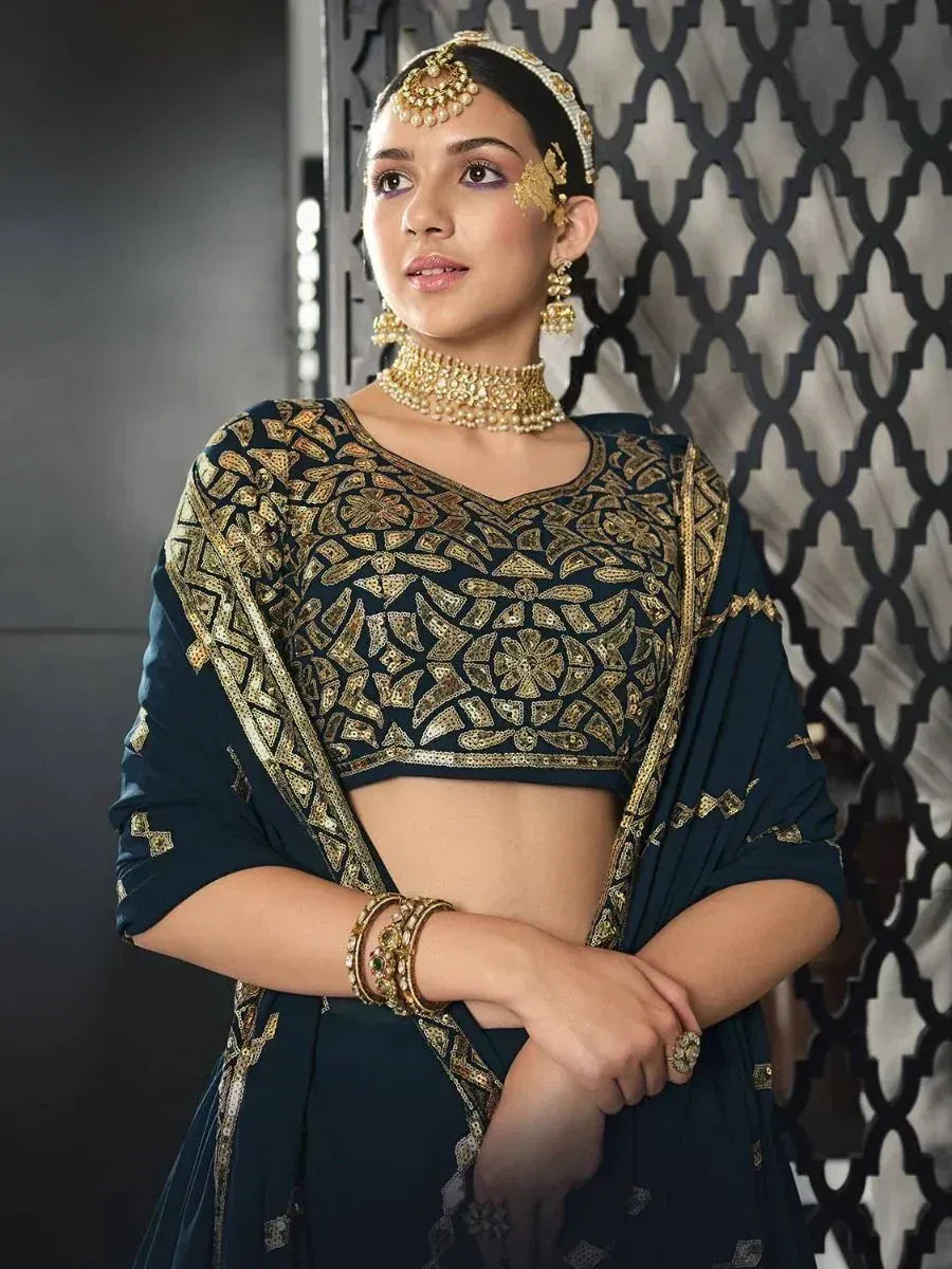 Elegant navy blue lehenga choli with gold embroidery, perfect for Indian weddings and festive occasions.