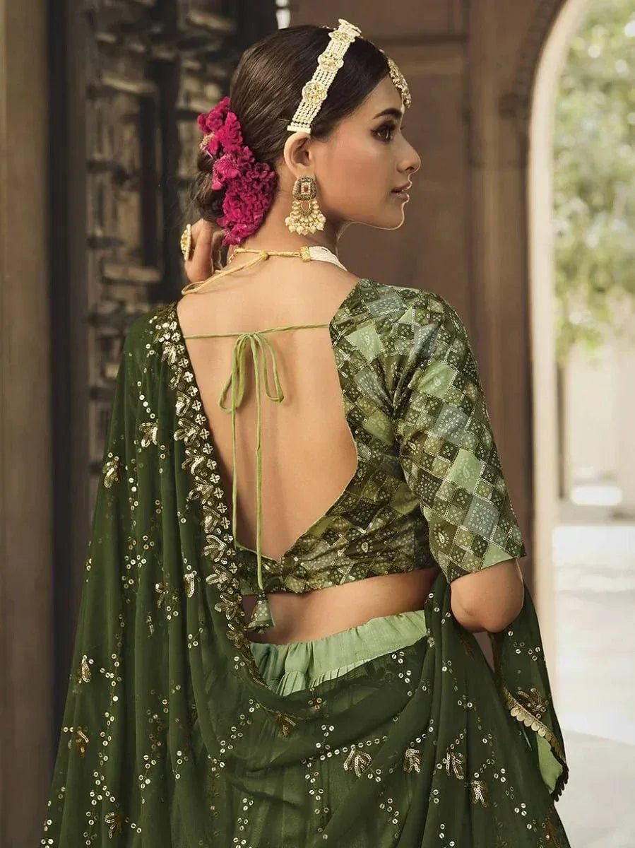 Green printed lehenga choli with open back blouse, sequin dupatta, and floral hair accessory
