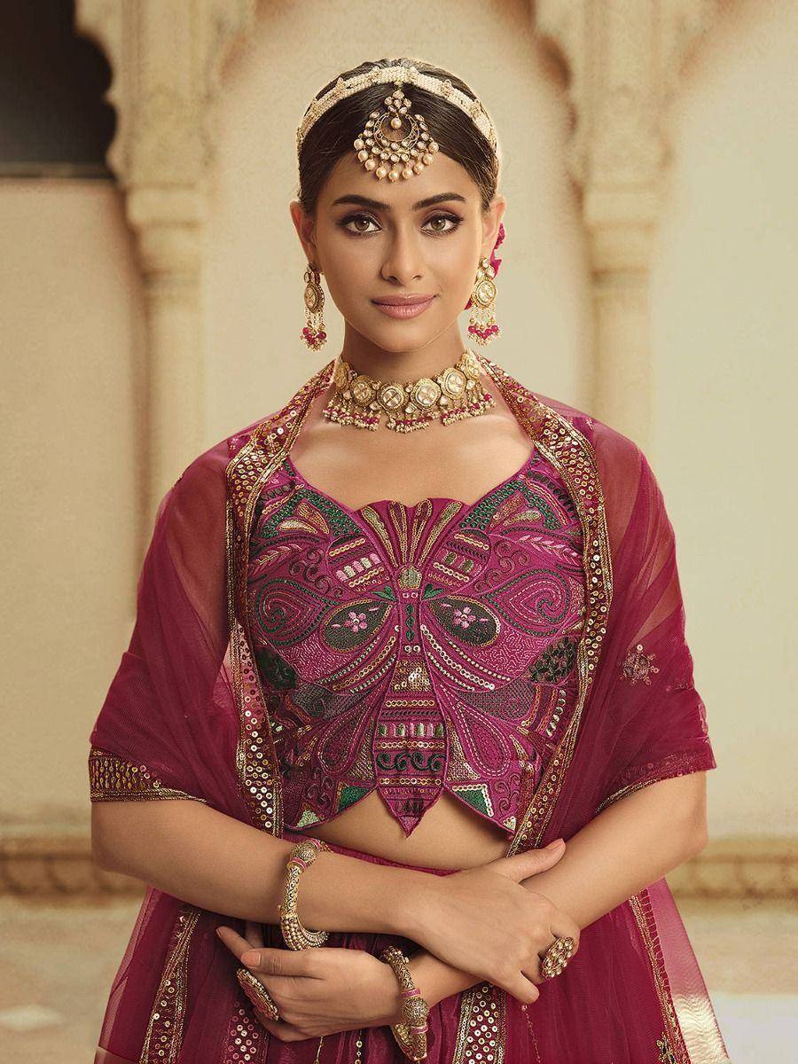 Elegant maroon lehenga choli with intricate embroidery and traditional Indian jewelry
