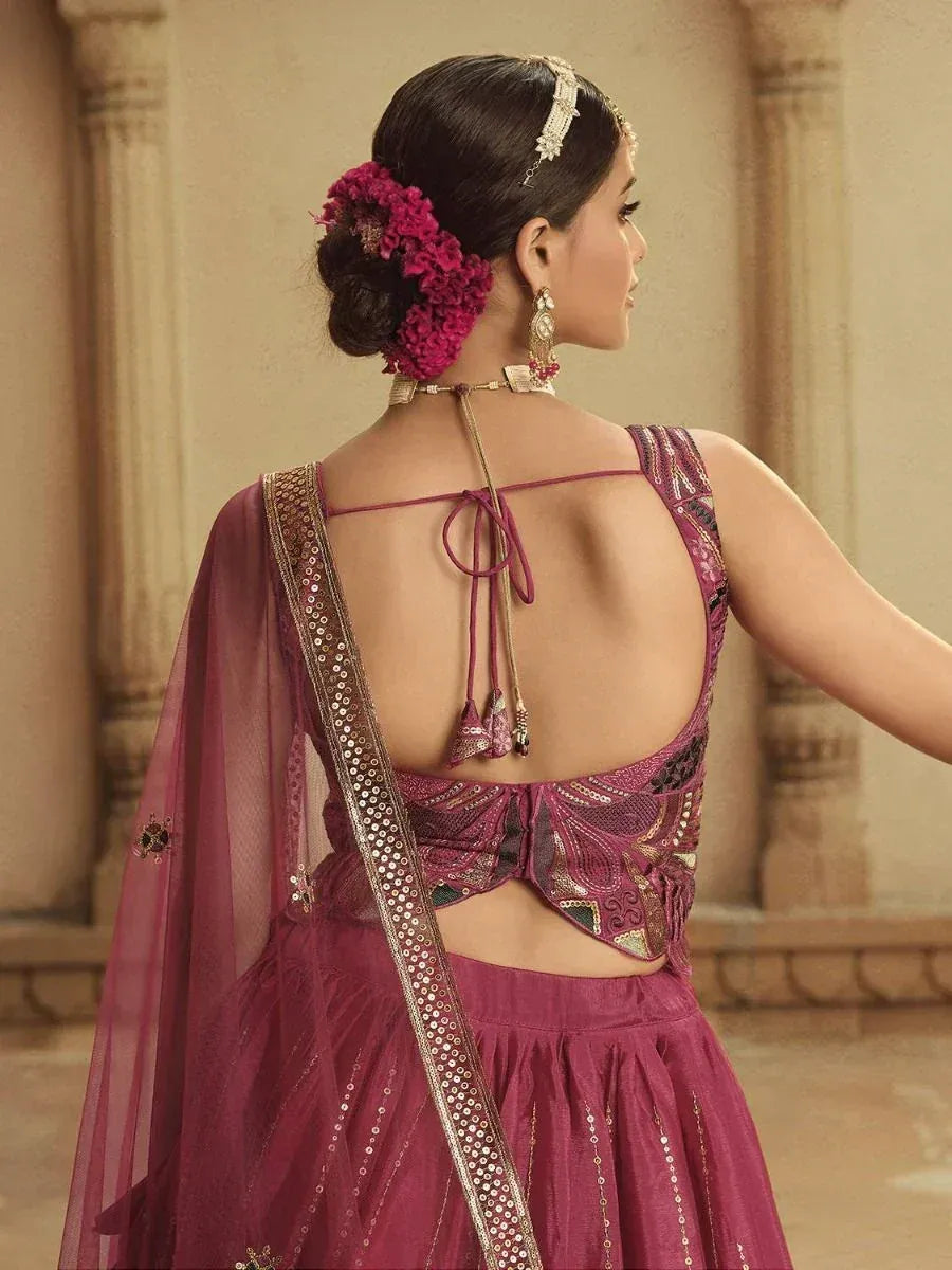Elegant maroon lehenga choli with back tie design, sequin embroidery, and floral hair accessory for Indian ethnic wear