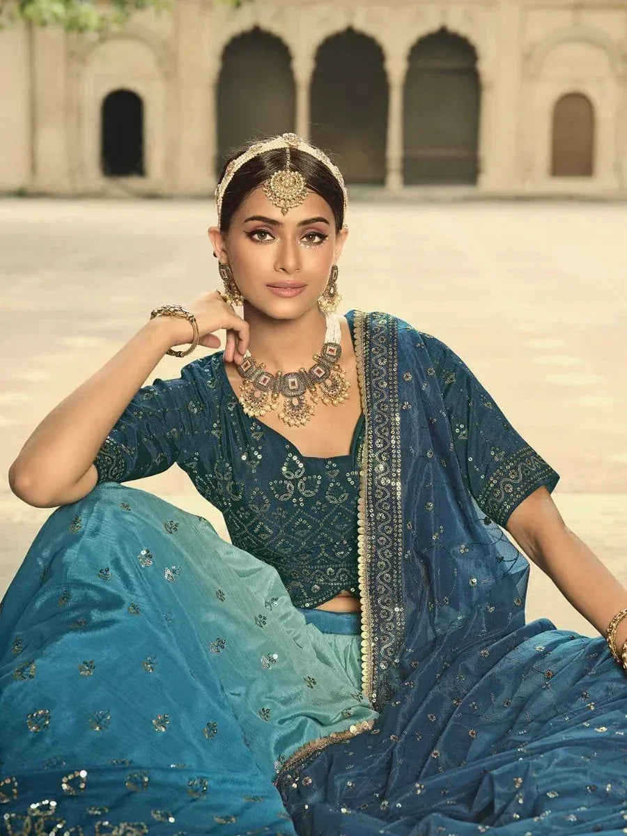 Blue embroidered lehenga choli with gold jewelry, perfect for Indian ethnic occasions