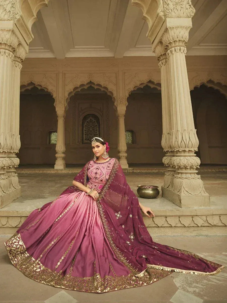 Elegant pink and maroon designer lehenga choli with gold embroidery, perfect for Indian weddings and festivals.