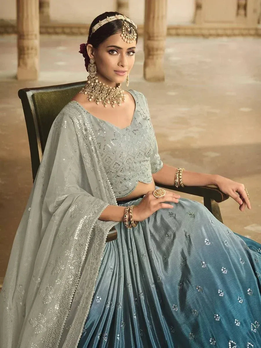 Elegant blue lehenga choli with sequin embroidery, perfect for Indian weddings and festive occasions.