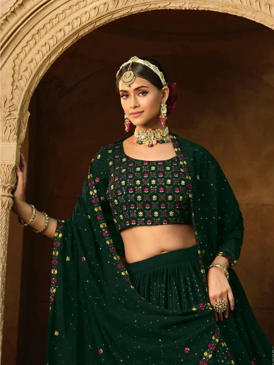 Green floral embroidered lehenga choli with traditional jewelry, perfect for Indian ethnic wear occasions.