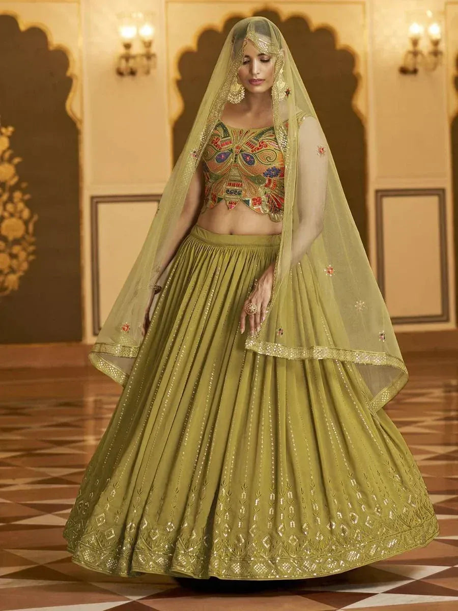 Olive green embroidered lehenga choli with sheer dupatta, perfect for Indian weddings and festive occasions.