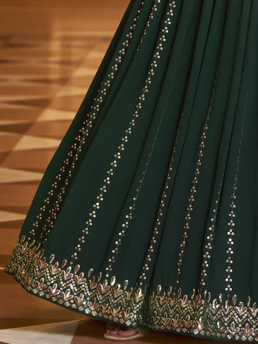 Emerald green lehenga skirt with gold sequin embroidery and pleated design, perfect for Indian ethnic wear.