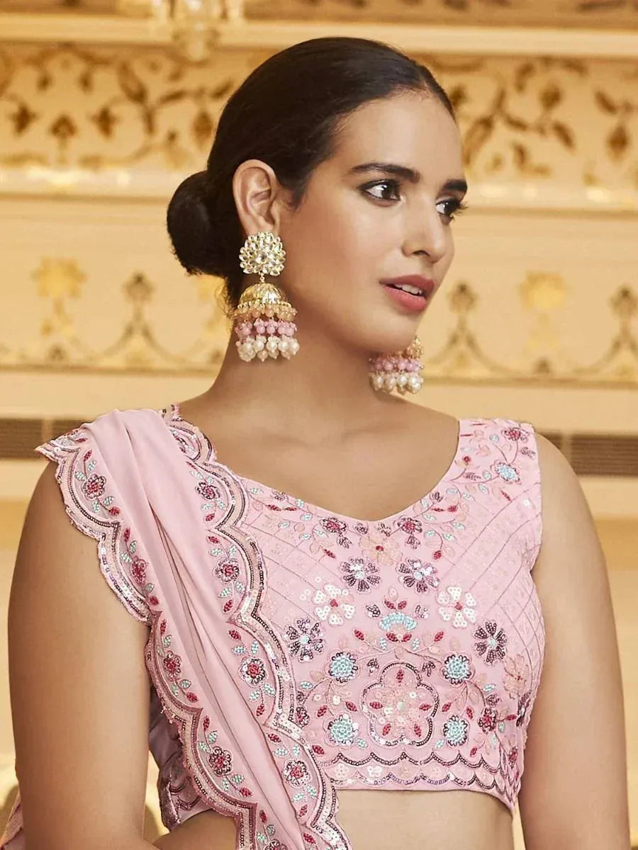 Pink embroidered lehenga choli top with floral sequin work and matching dupatta, styled with jhumka earrings