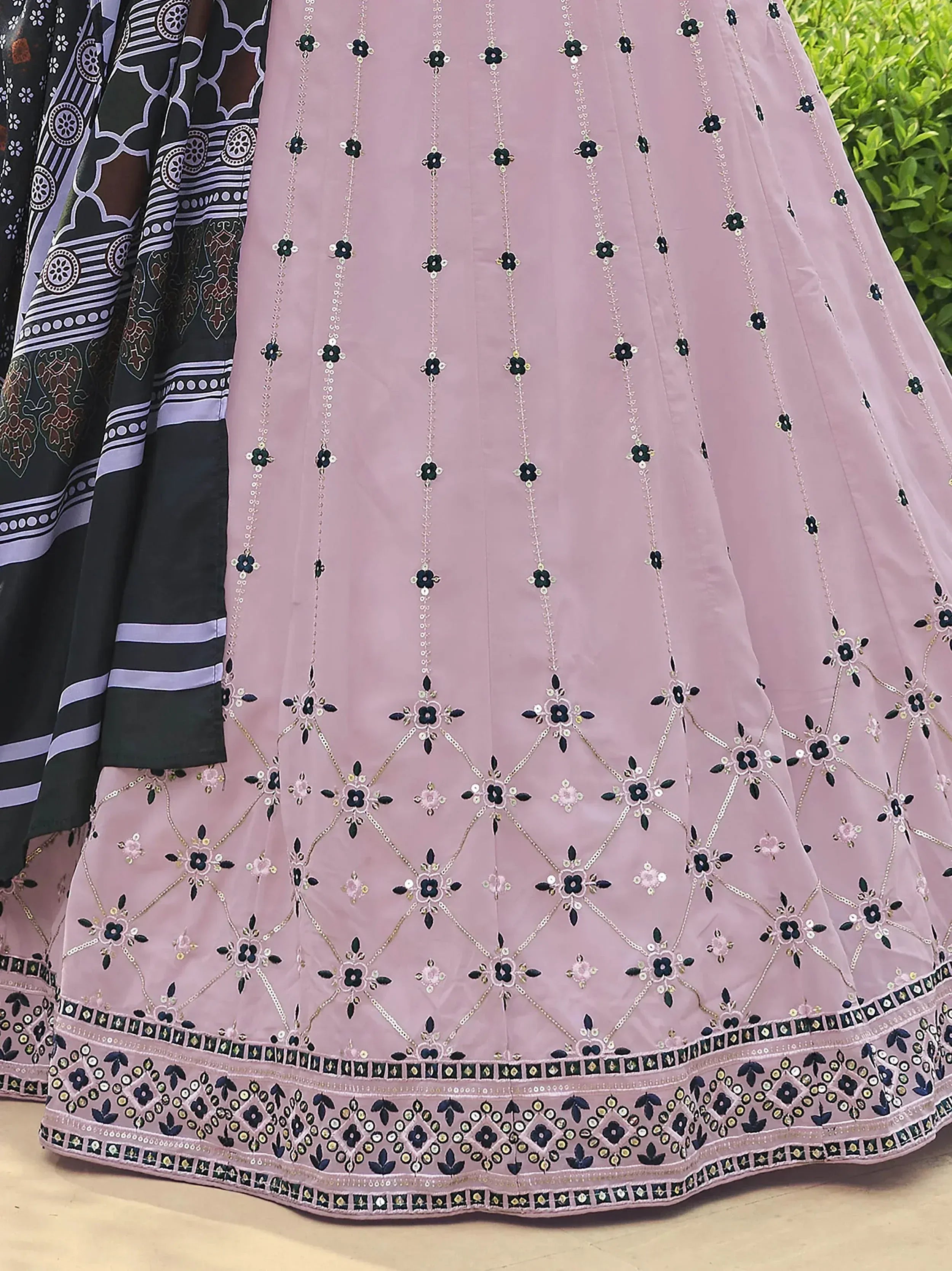 Pink embroidered lehenga with black floral motifs and sequin detailing, paired with printed dupatta