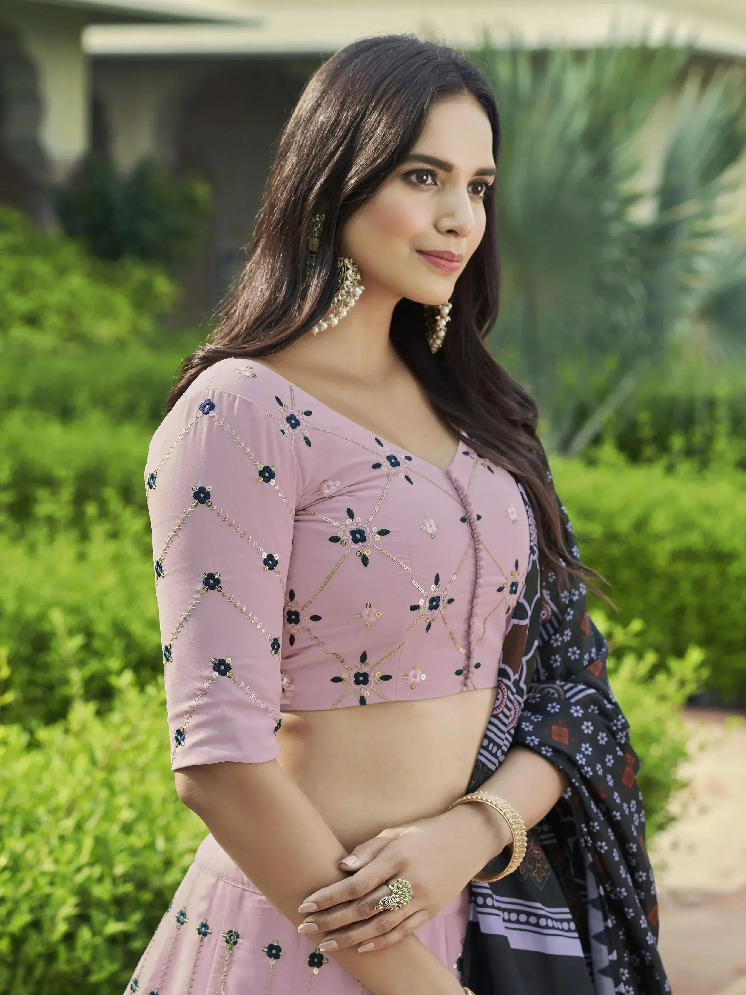 Pink embroidered lehenga choli with floral detailing, paired with patterned dupatta for Indian ethnic wear