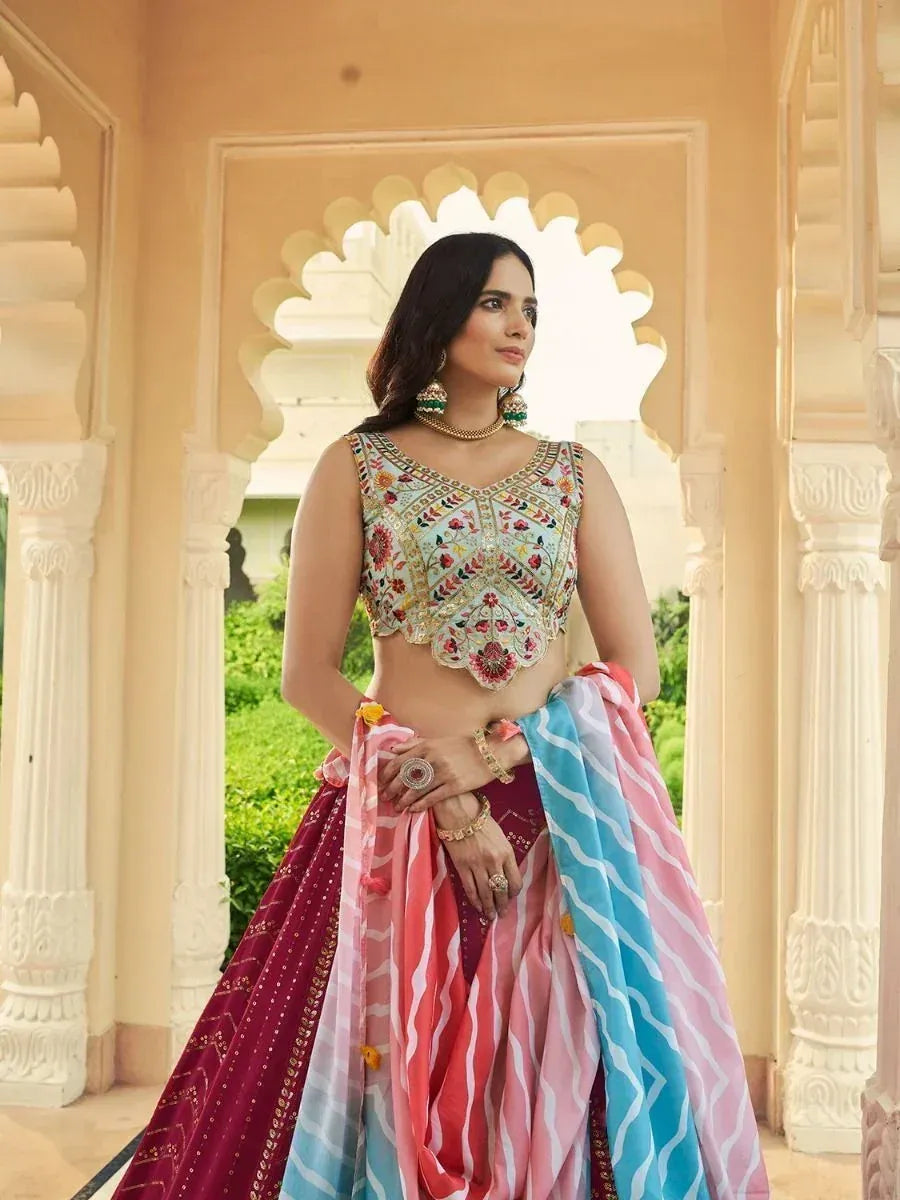 Woman in embroidered lehenga choli with colorful dupatta, traditional Indian ethnic wear