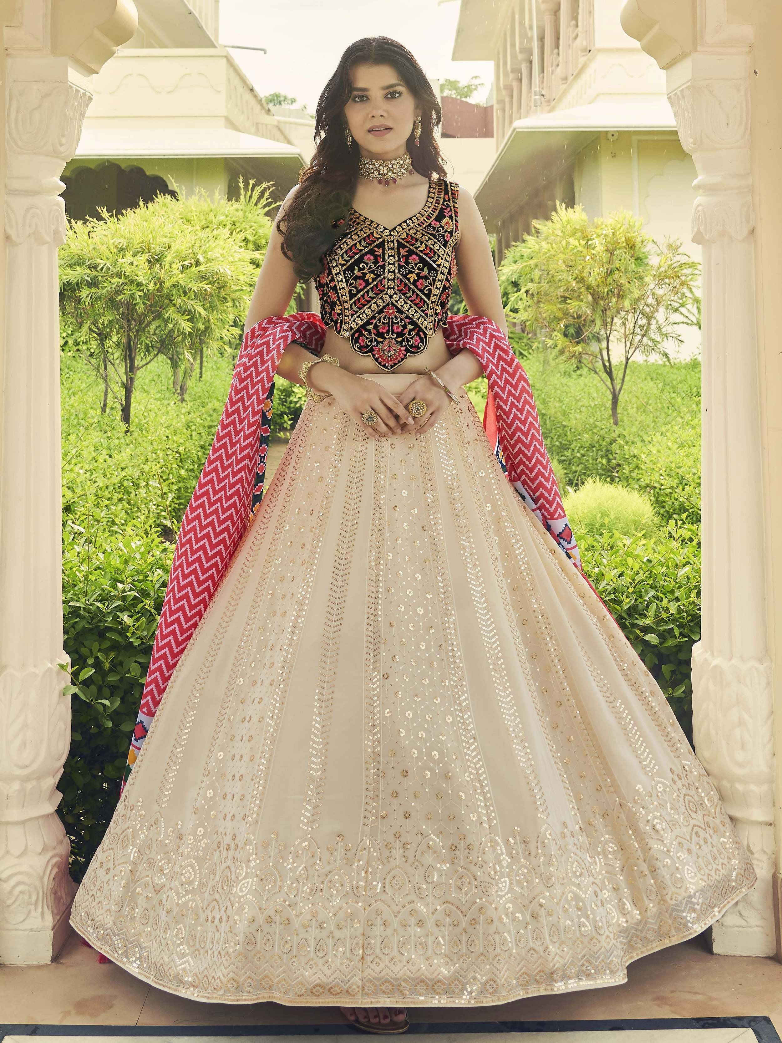 Woman in embroidered black blouse and beige lehenga with red dupatta, Indian ethnic wear