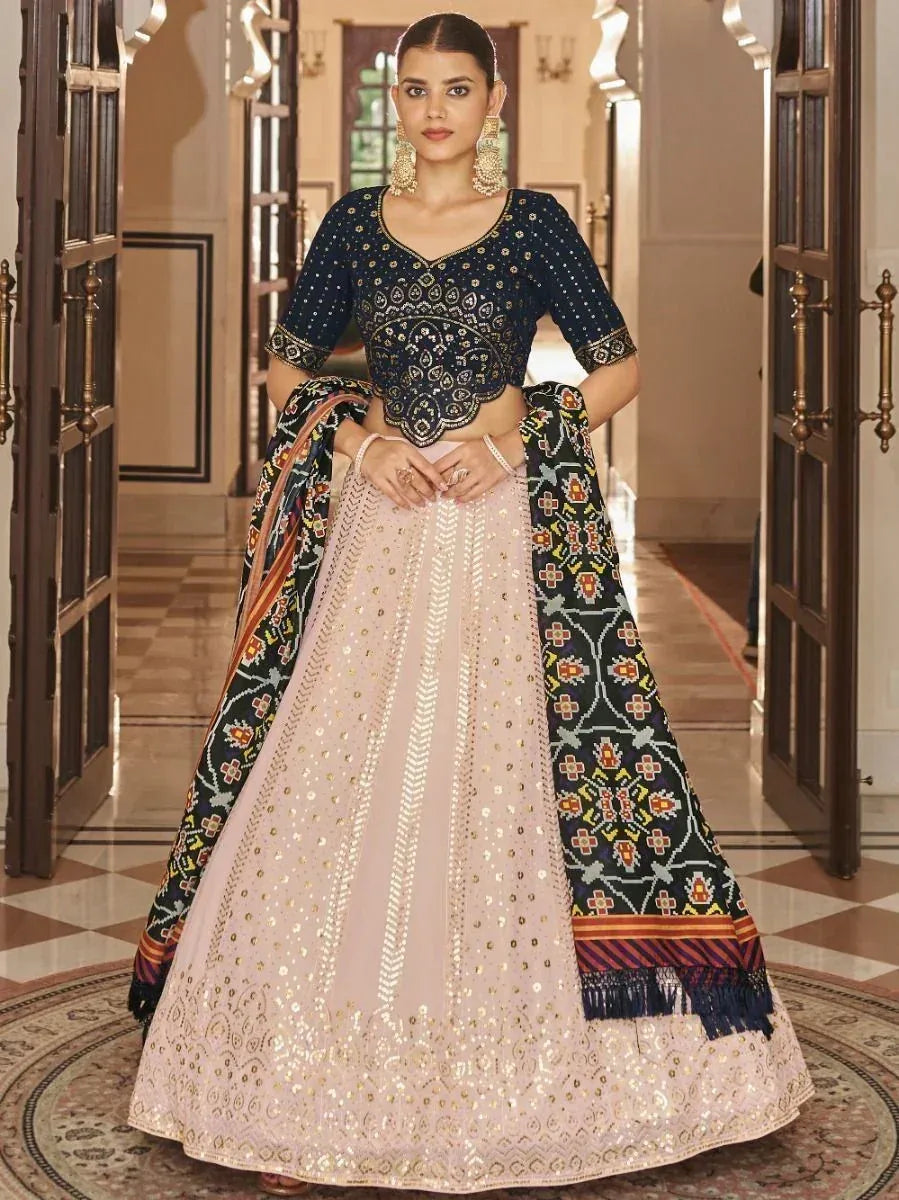 Elegant navy blue and blush pink lehenga choli with intricate embroidery and dupatta, perfect for Indian ethnic wear occasions.