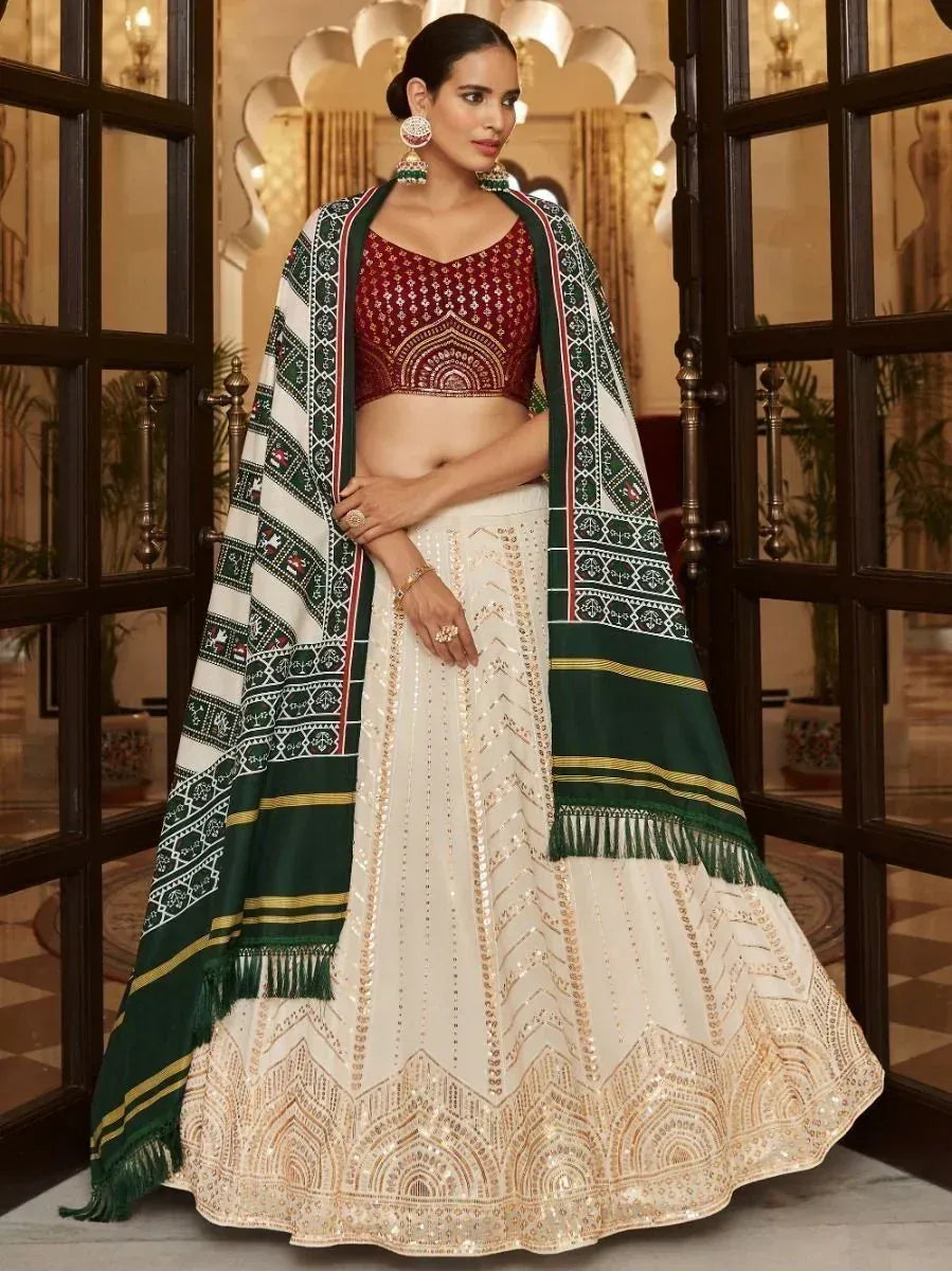 Elegant white lehenga with gold embroidery, maroon blouse, and green patterned dupatta for Indian ethnic wear