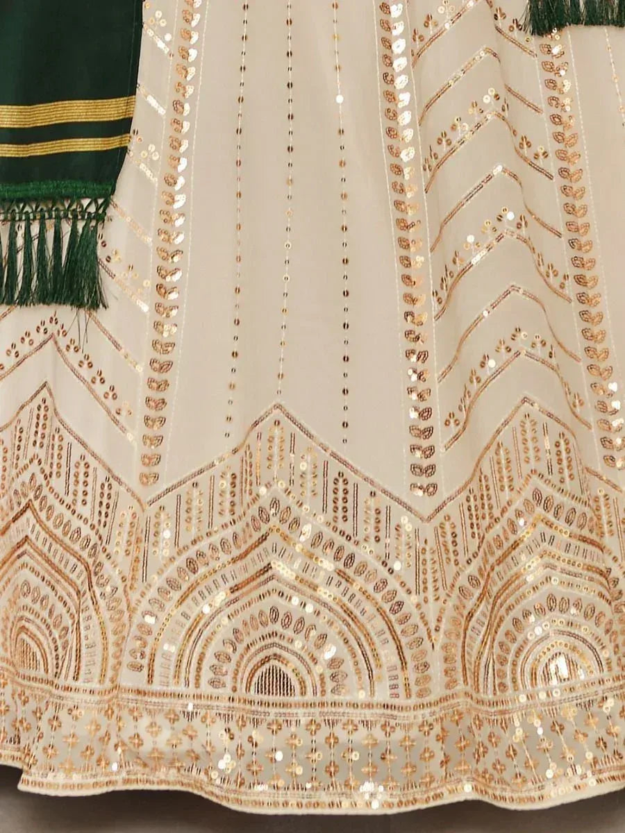 Cream ethnic gown with gold sequin embroidery and green dupatta, perfect for Indian festive occasions.