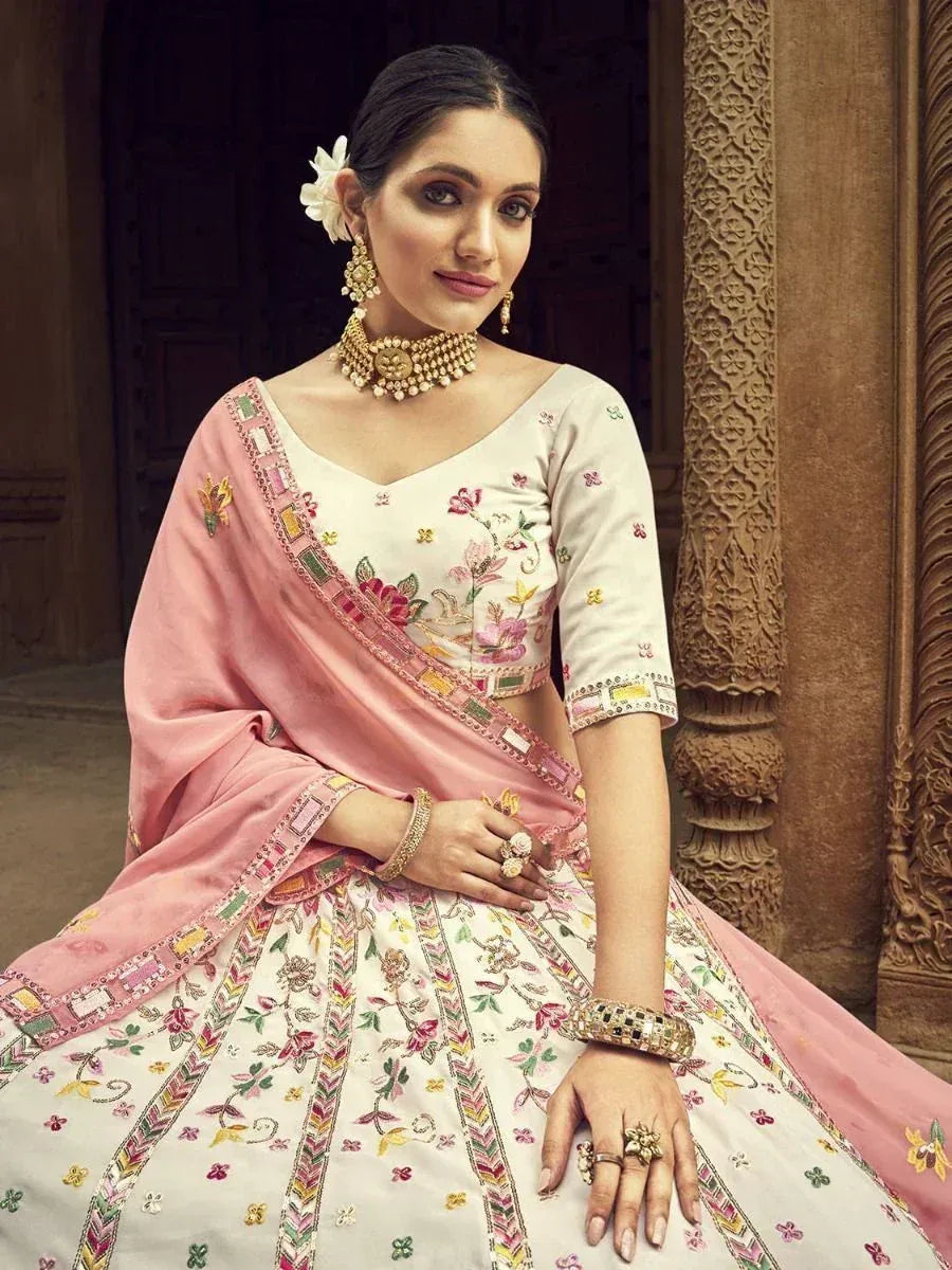 Elegant white and pink embroidered lehenga choli with floral motifs, perfect for Indian ethnic occasions