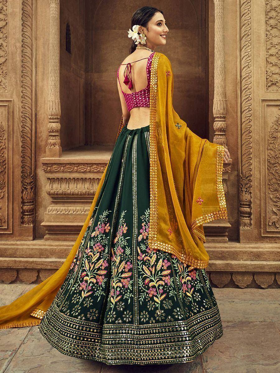 Elegant green lehenga choli with floral embroidery, pink blouse, and mustard dupatta for Indian ethnic wear