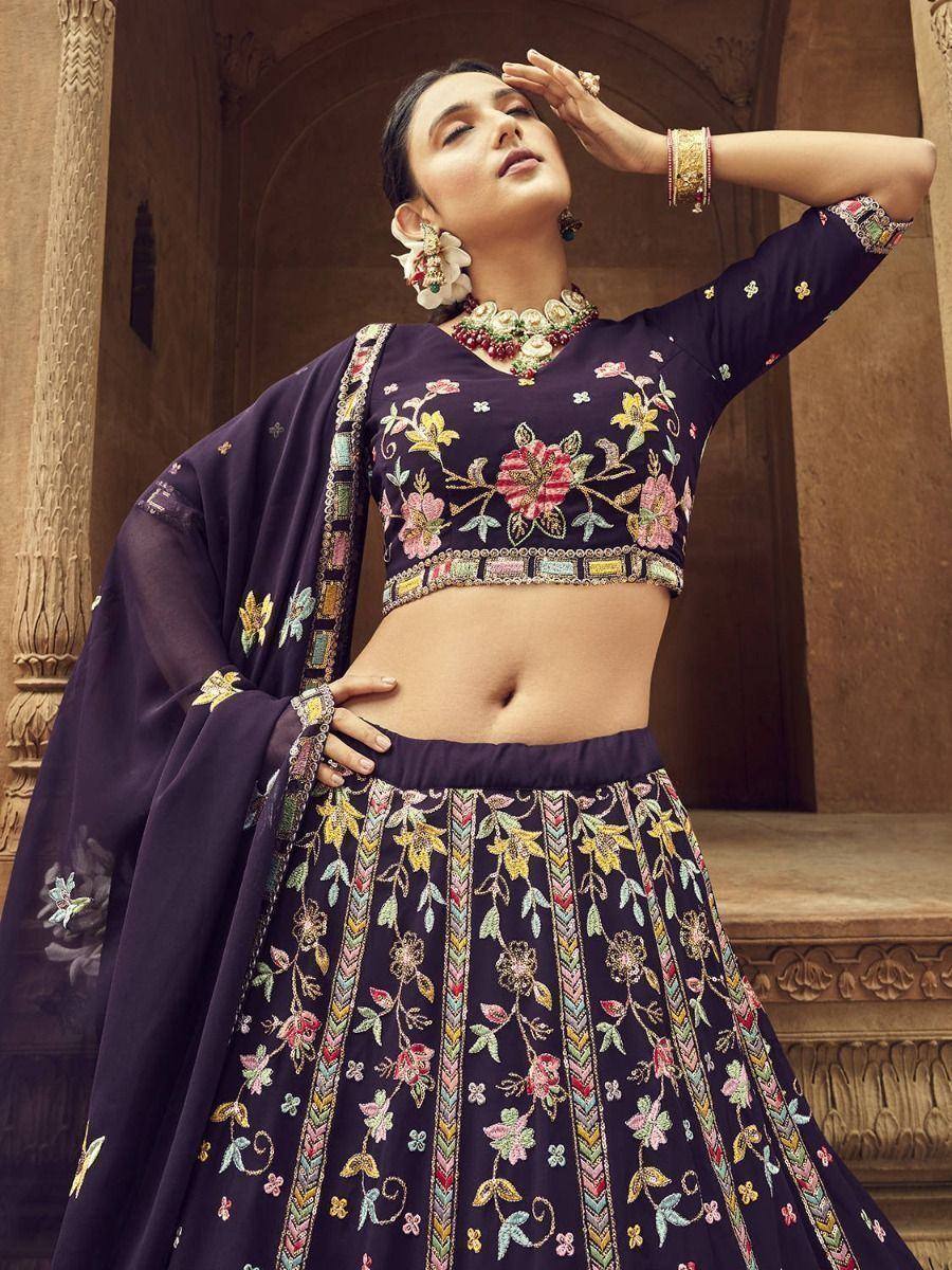 Elegant purple embroidered lehenga choli with floral motifs, perfect for Indian ethnic occasions.