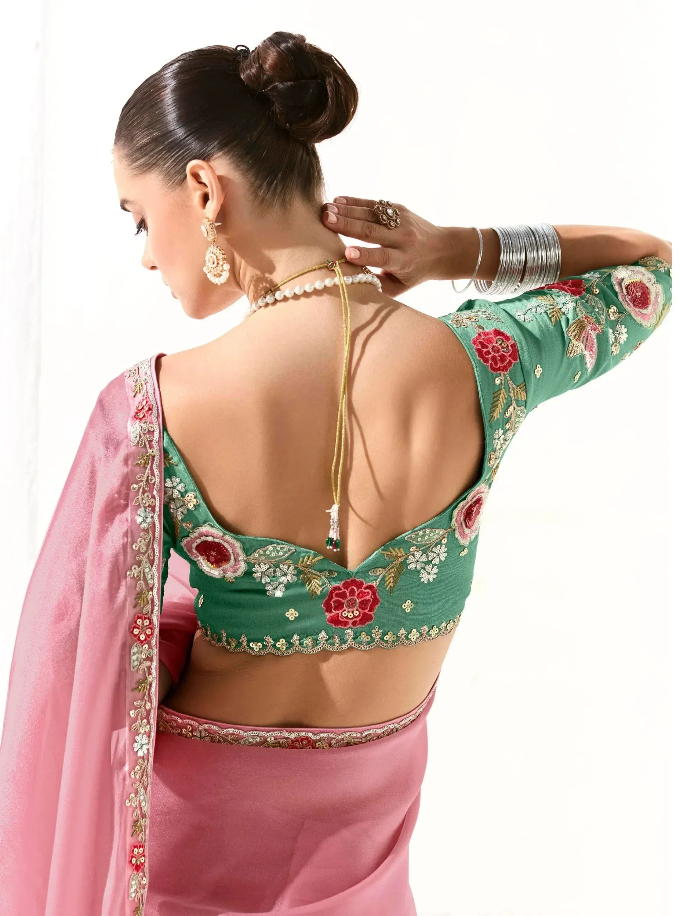 Green floral embroidered backless blouse with pink saree, perfect for Indian ethnic wear