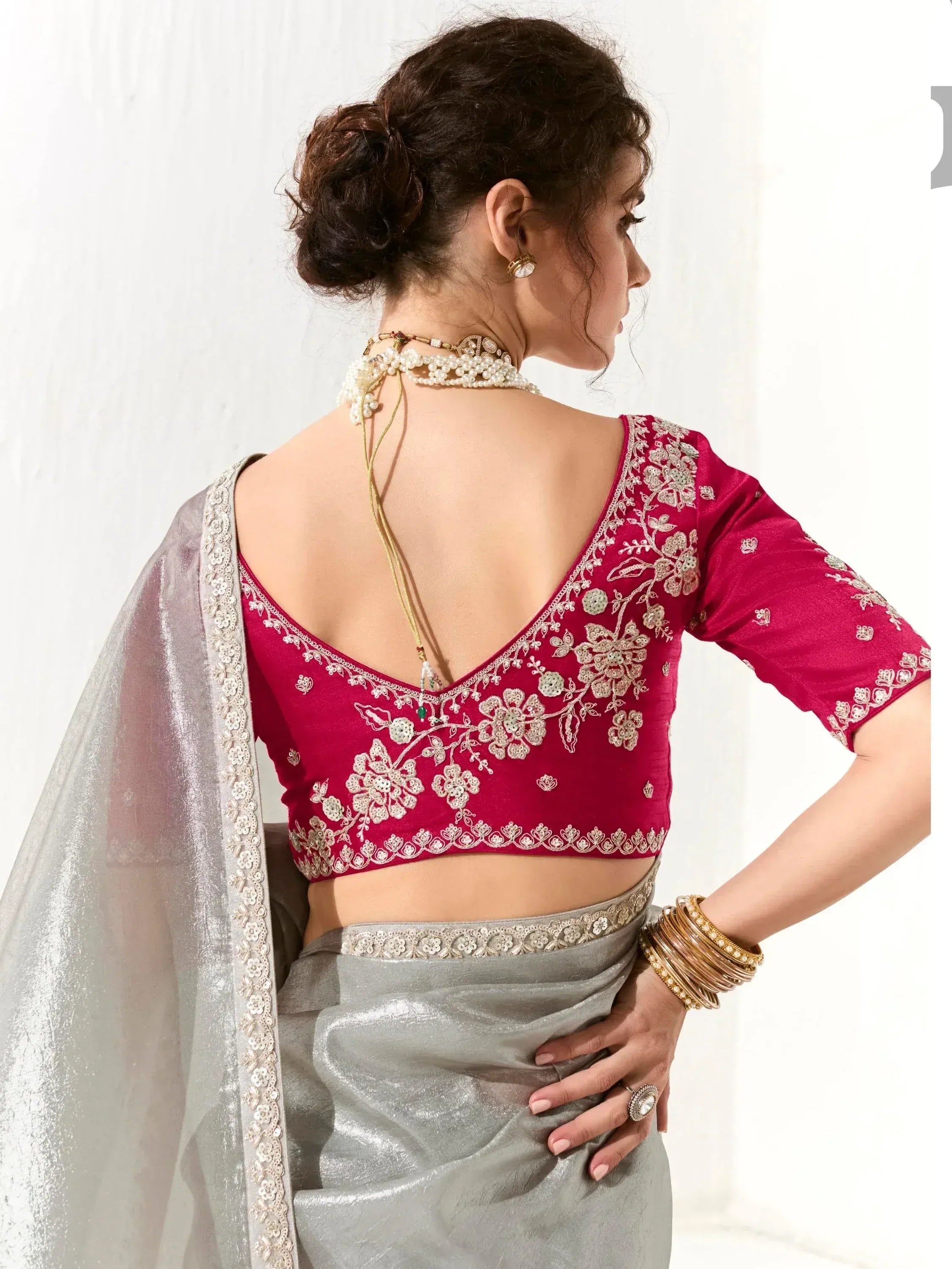 Red embroidered blouse with silver saree, floral detailing and backless design for ethnic wear