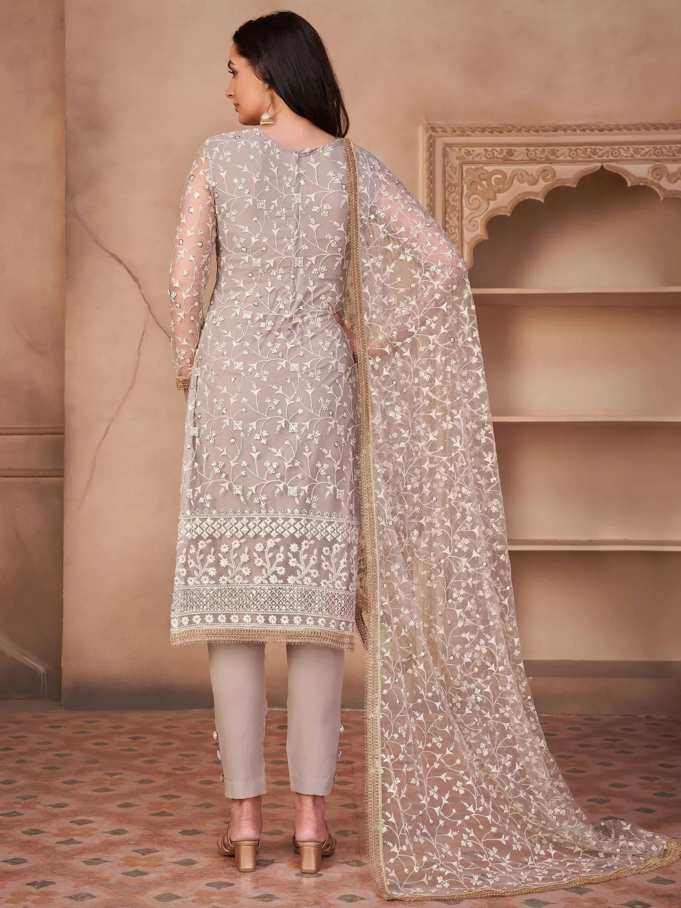 Elegant grey embroidered salwar kameez with floral net dupatta, perfect for Indian ethnic occasions.