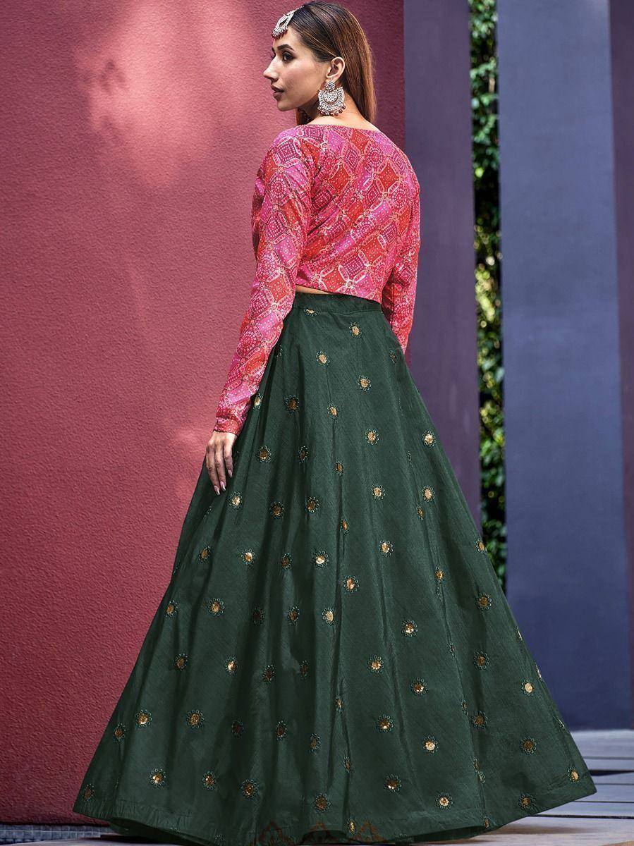 Woman in pink printed blouse and green embroidered lehenga, ethnic Indian wear