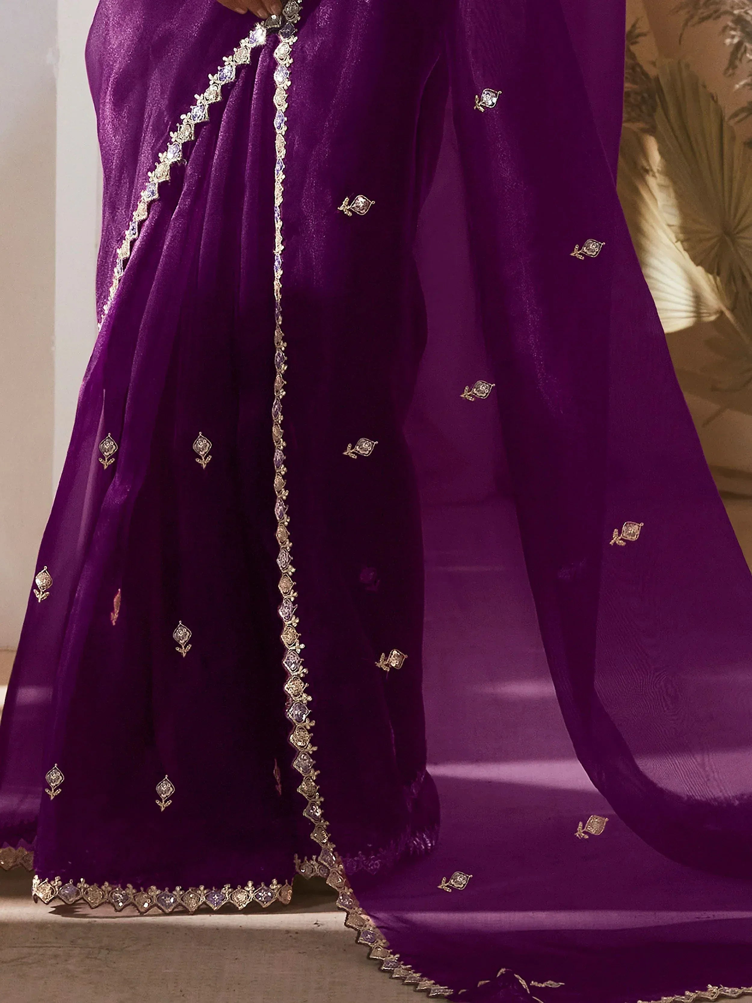 Purple velvet ethnic gown with gold and stone embroidery, perfect for Indian weddings and festive occasions.