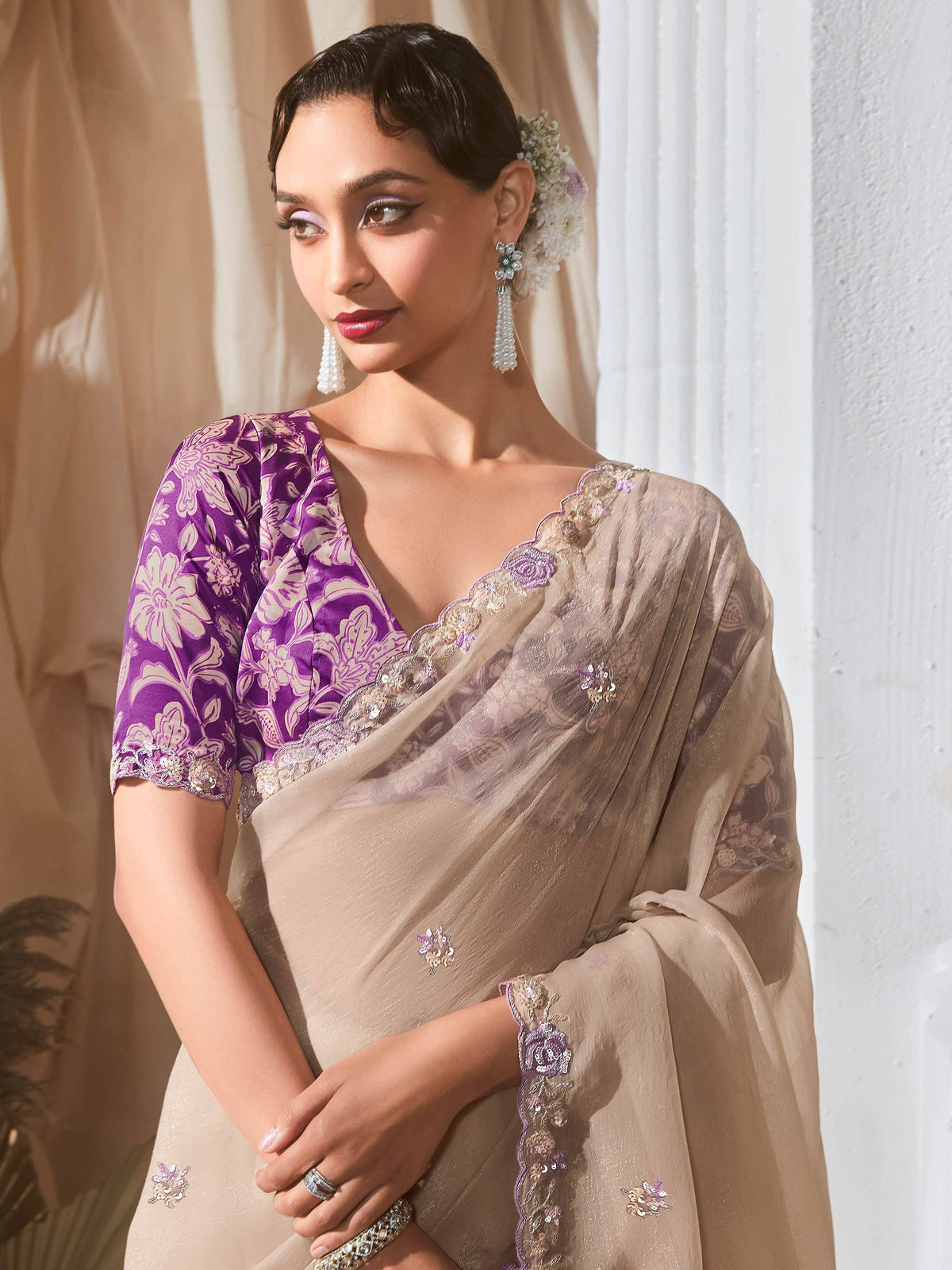 Elegant beige saree with purple floral blouse, perfect for Indian ethnic wear occasions