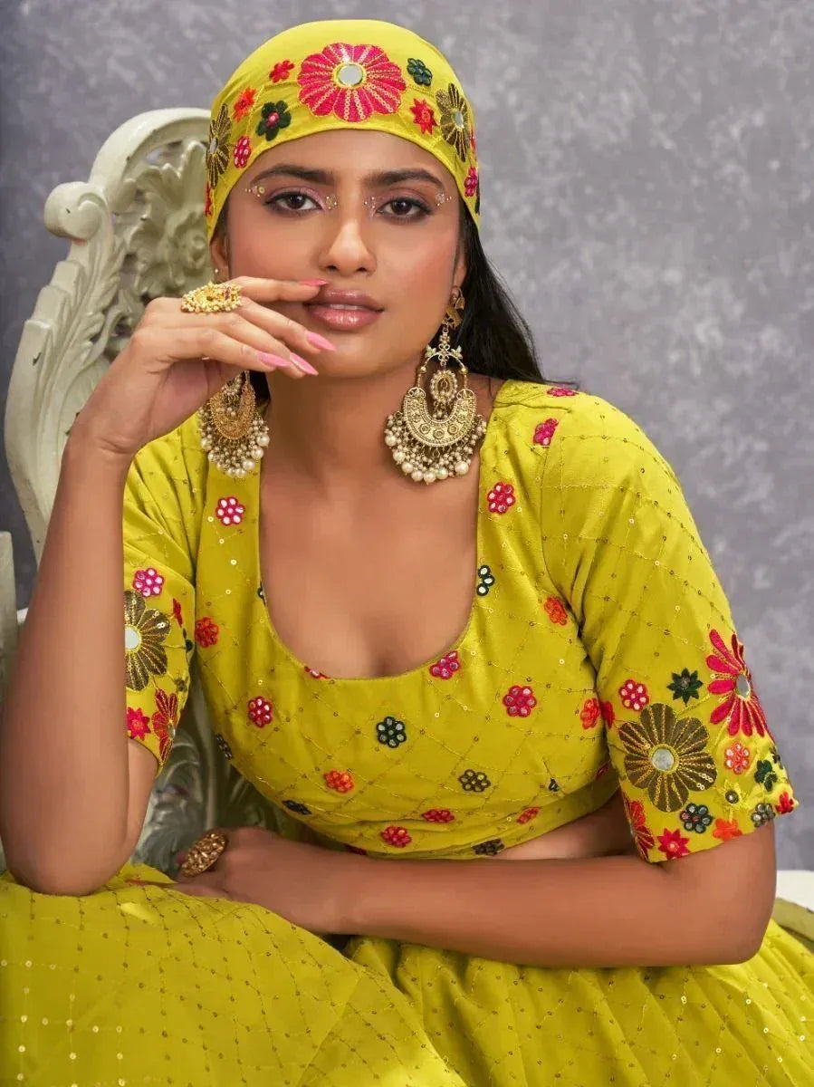 Yellow floral embroidered lehenga choli with matching headpiece and jhumka earrings