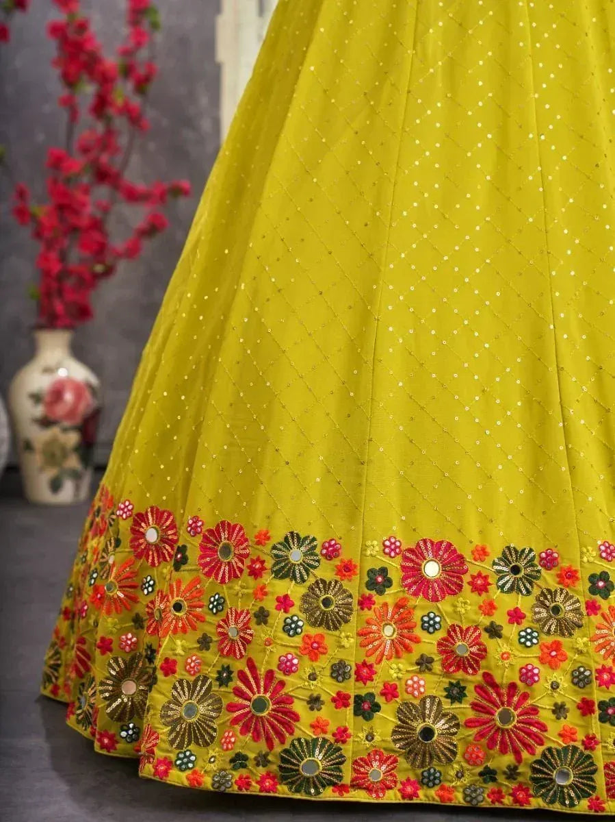 Vibrant yellow lehenga with floral embroidery and mirror work, perfect for Indian ethnic wear occasions