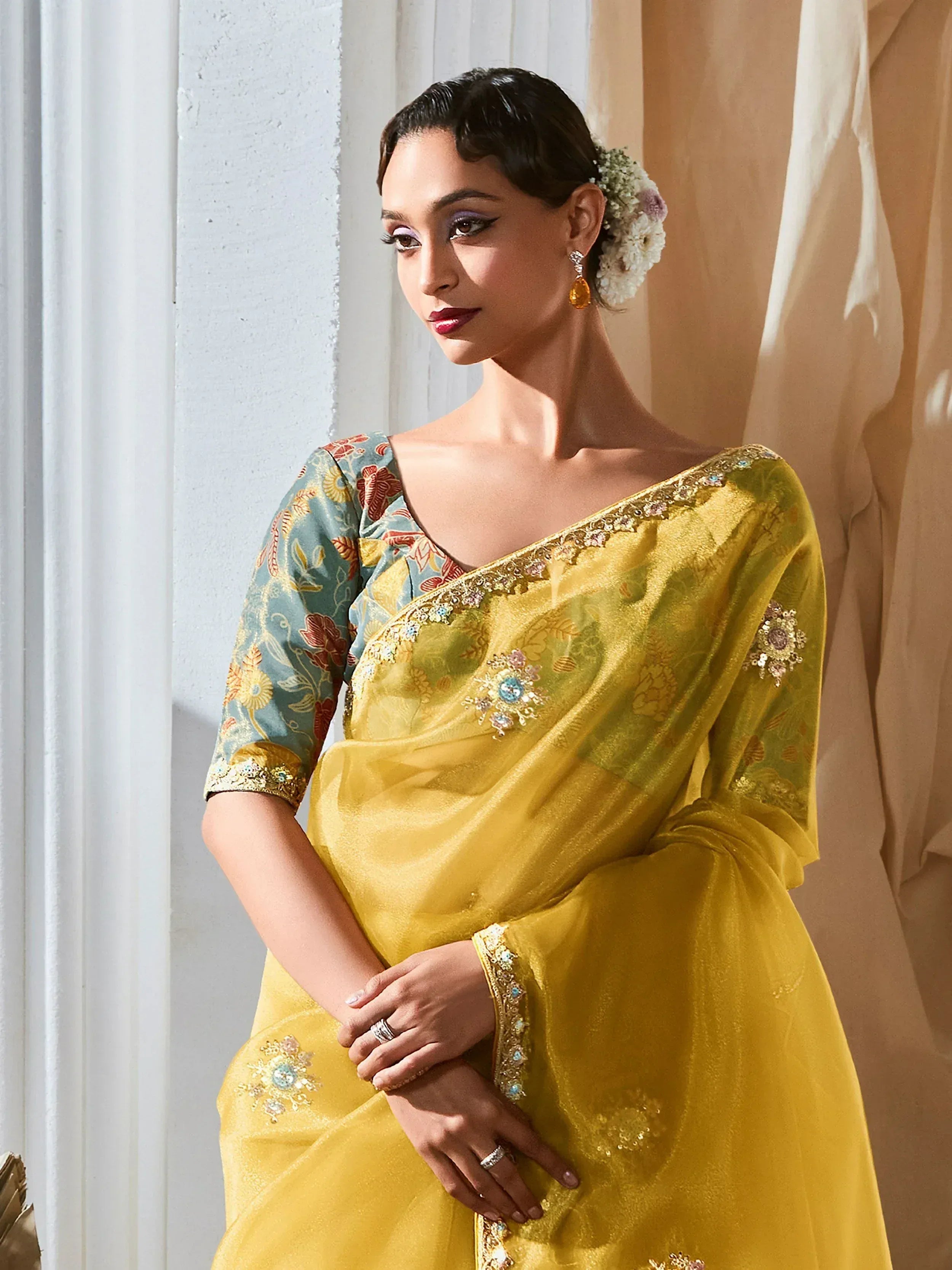Yellow embroidered saree with floral blouse, perfect for Indian ethnic occasions and festive wear.