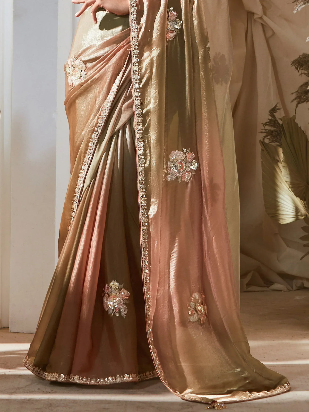 Elegant gold and rose gold saree with floral embroidery and sequin border, perfect for Indian ethnic wear