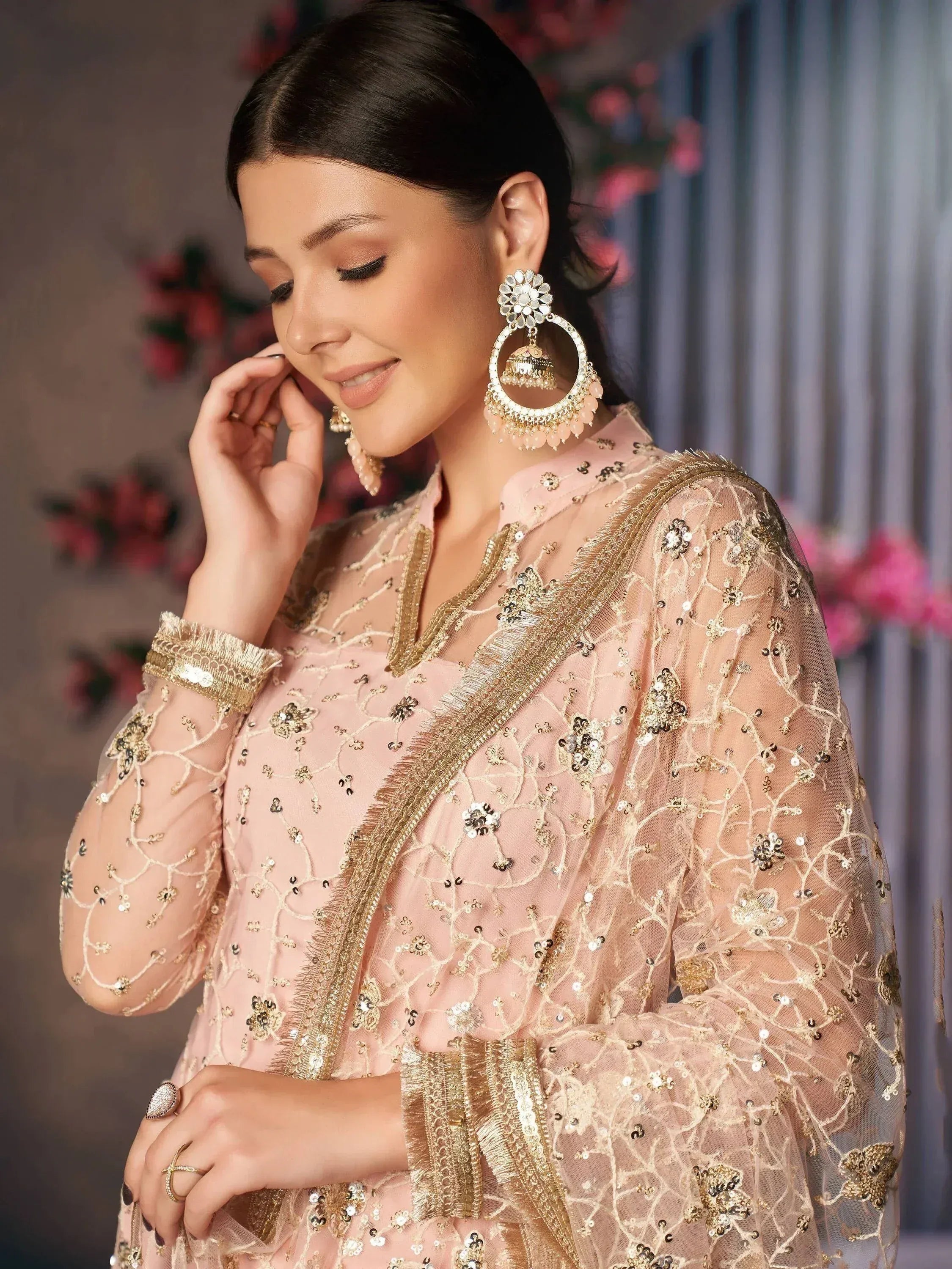 Elegant pink ethnic gown with gold embroidery and jhumka earrings for Indian festive wear