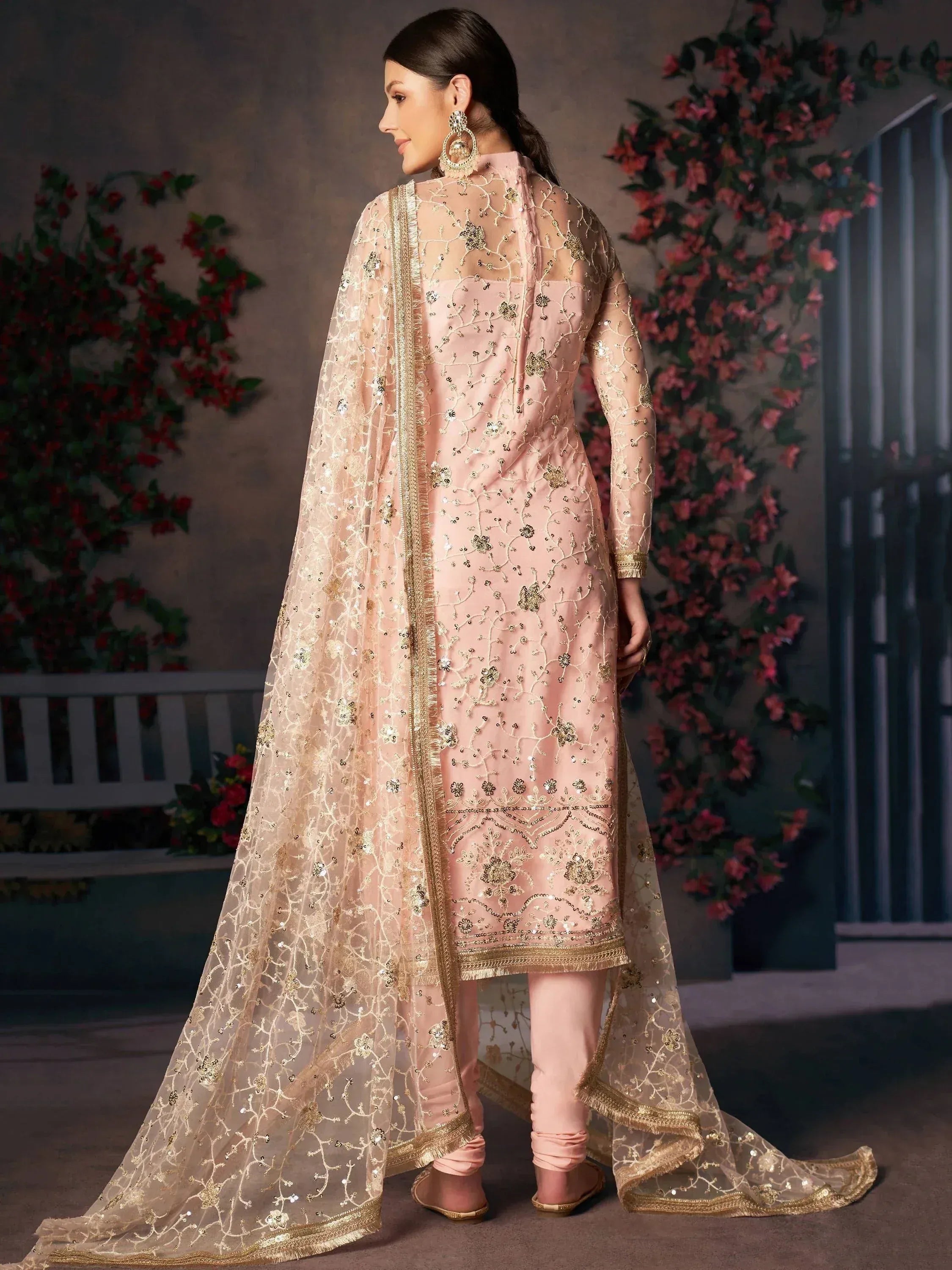 Elegant pink embroidered salwar kameez with gold detailing and sheer dupatta, perfect for Indian ethnic occasions.
