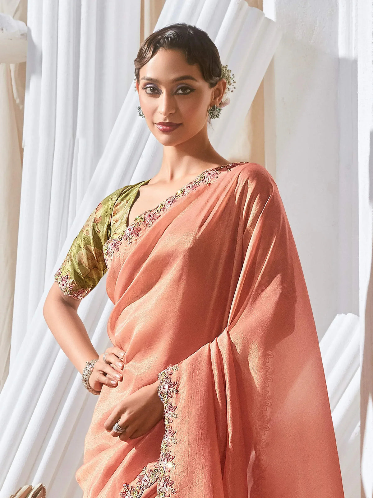 Elegant peach saree with floral embroidery and green blouse, perfect for Indian ethnic occasions