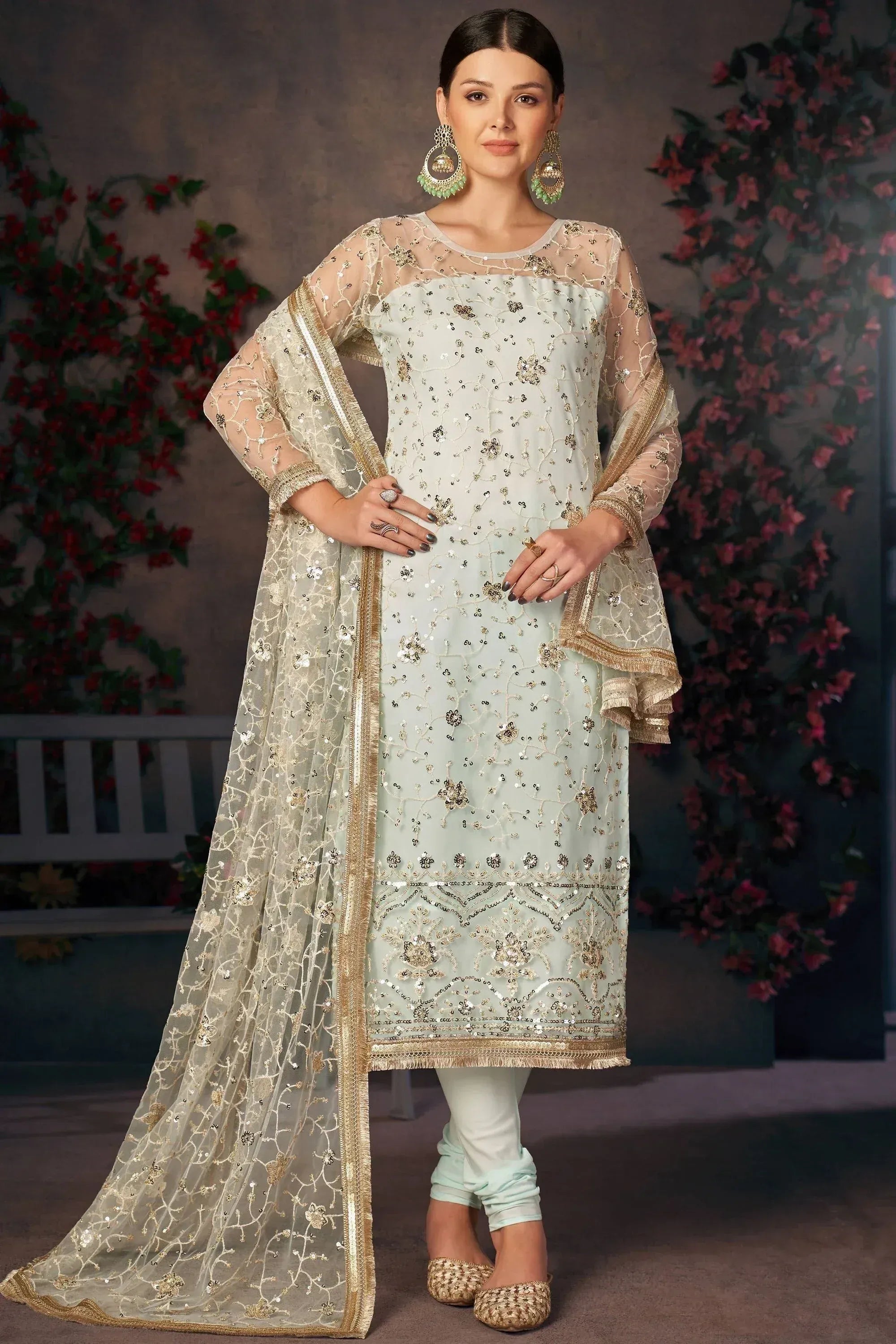 Mint green embroidered salwar kameez with sheer dupatta, gold detailing, and matching churidar for festive occasions