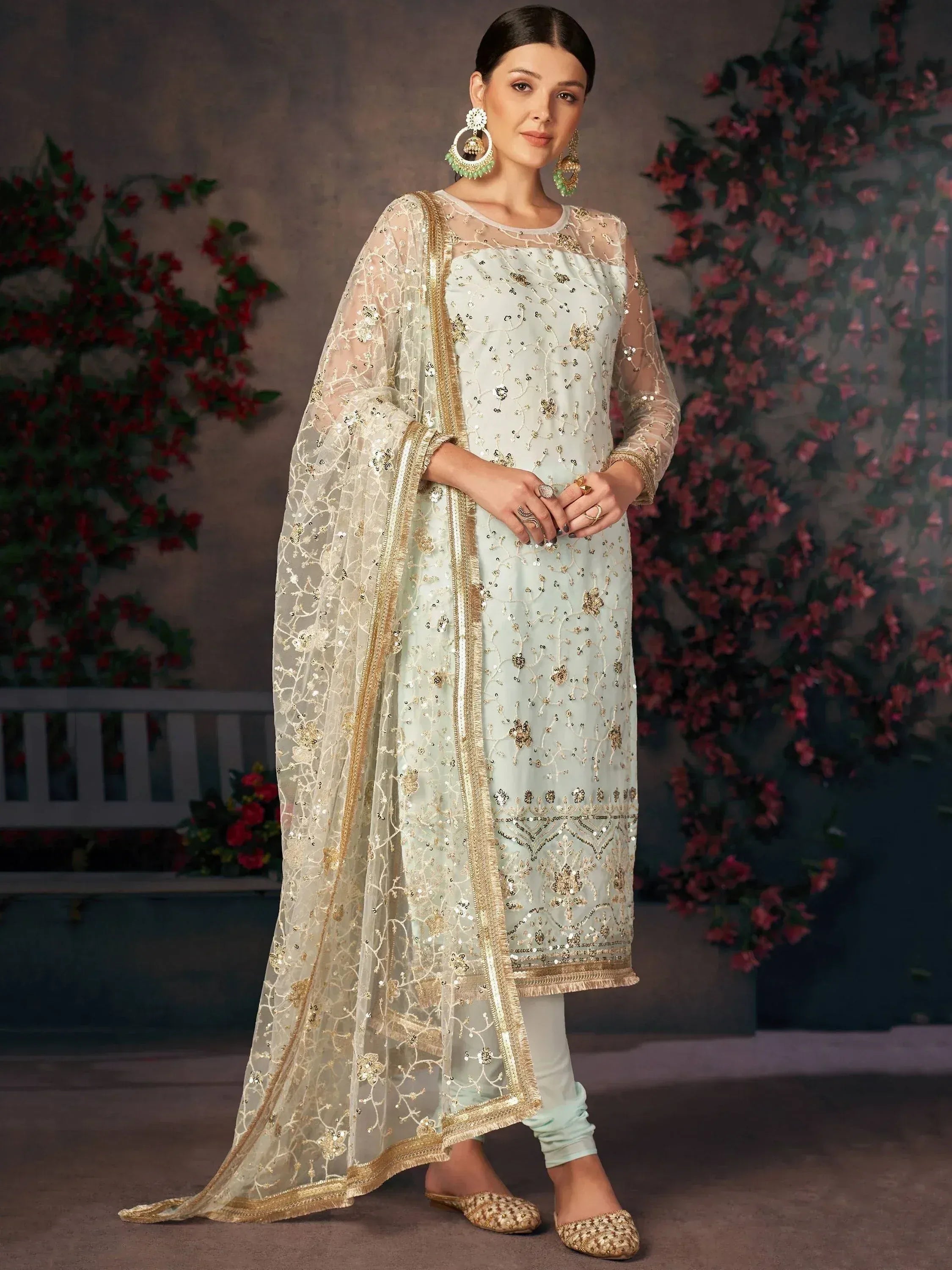 Mint green embroidered salwar kameez with gold detailing and sheer dupatta, perfect for Indian ethnic occasions.