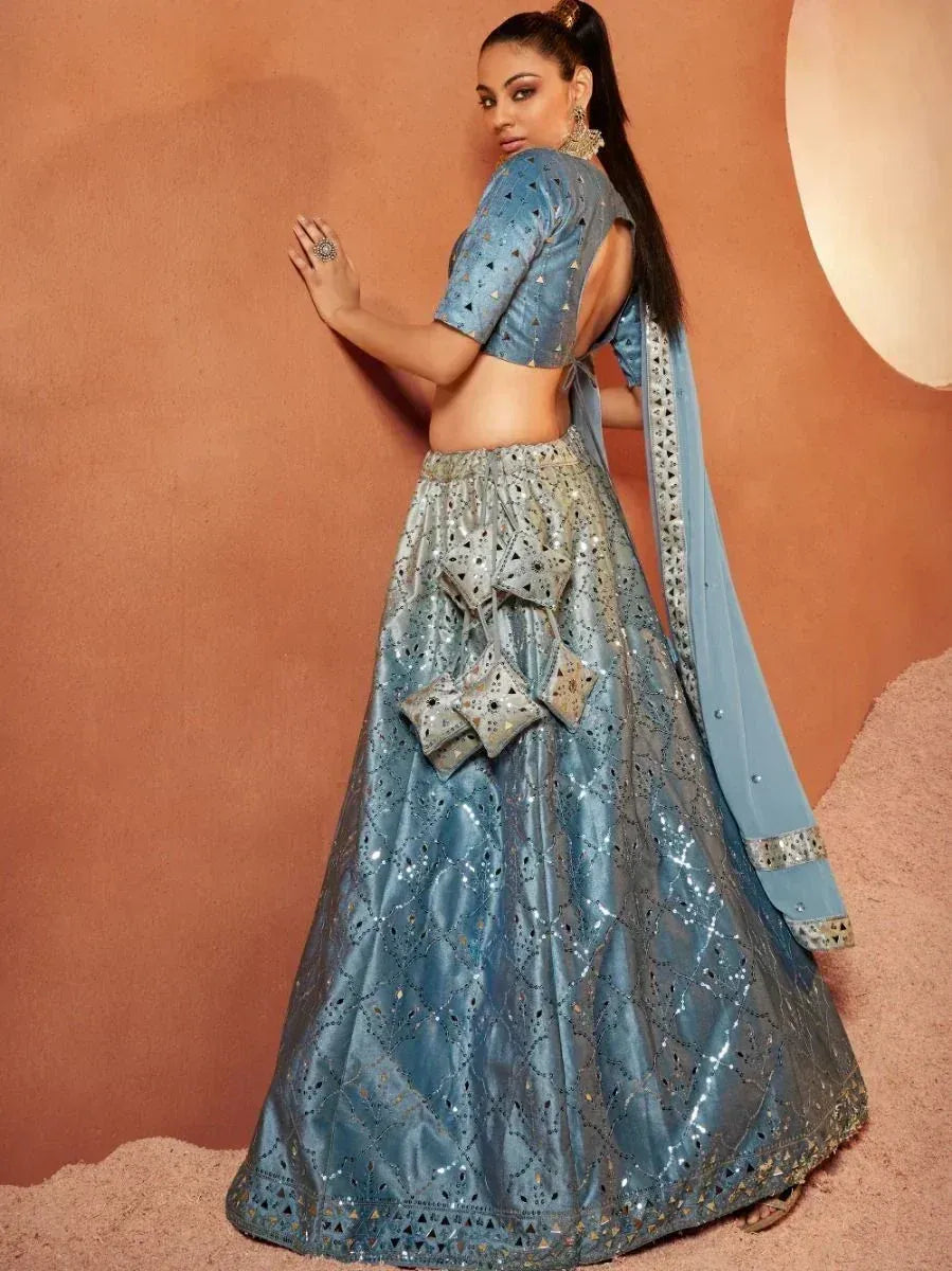 Blue designer lehenga choli with mirror work and cut-out back, perfect for Indian ethnic occasions