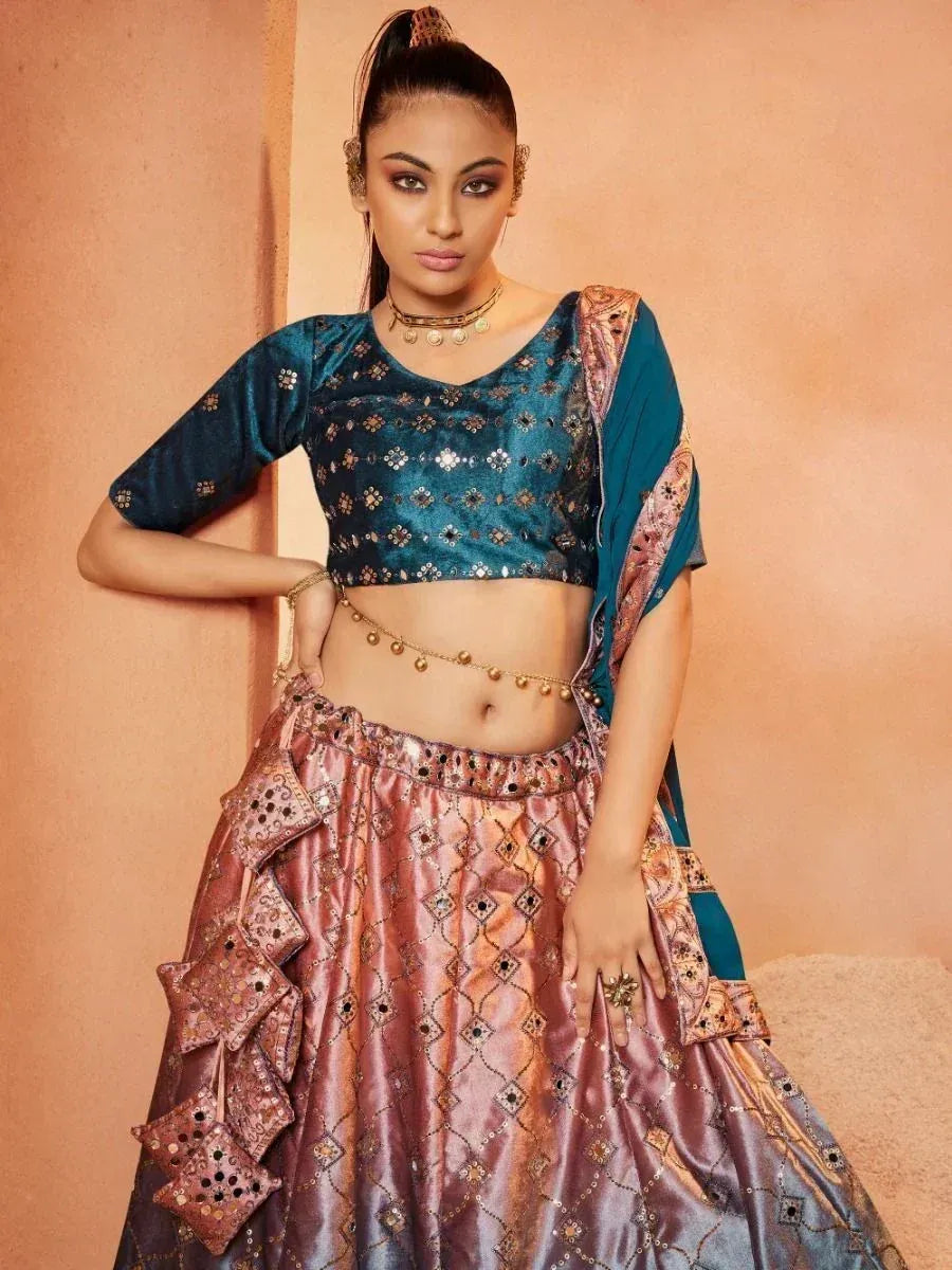 Teal and pink designer lehenga choli with mirror work and gold embellishments, perfect for ethnic occasions