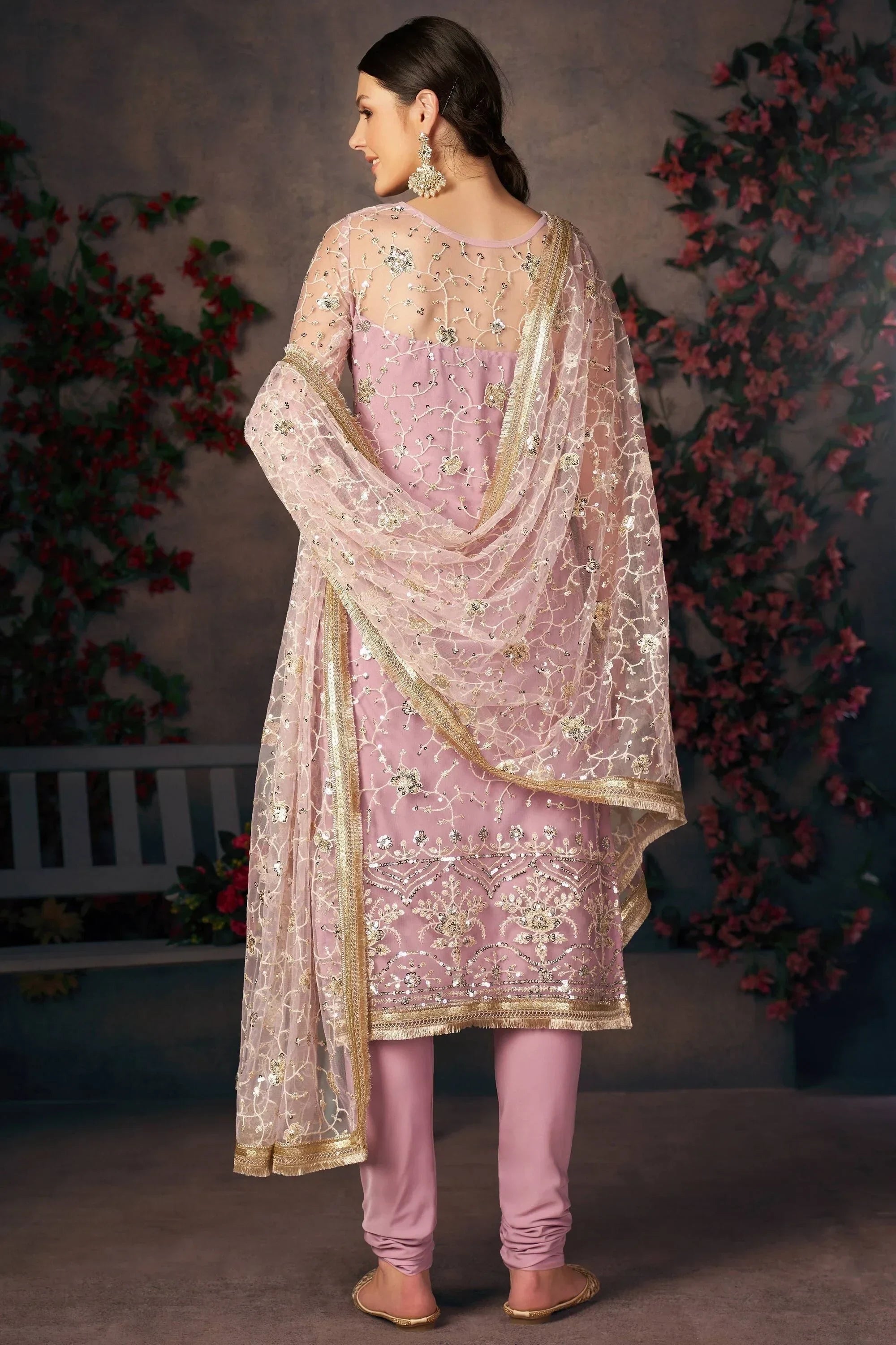 Woman in light pink embroidered salwar kameez with sheer dupatta, ethnic wear style