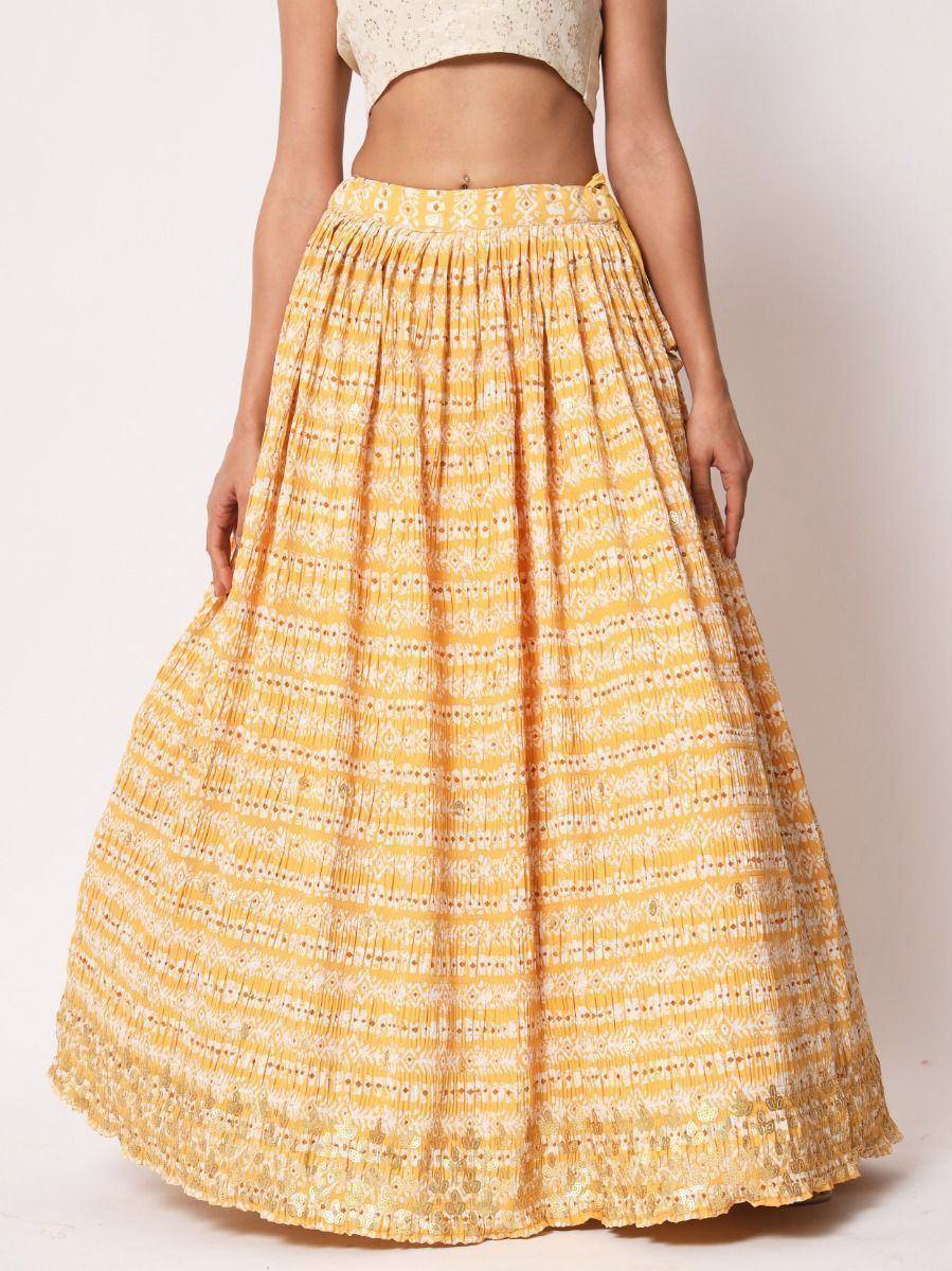 Yellow printed pleated lehenga skirt with white floral patterns, ethnic wear for women